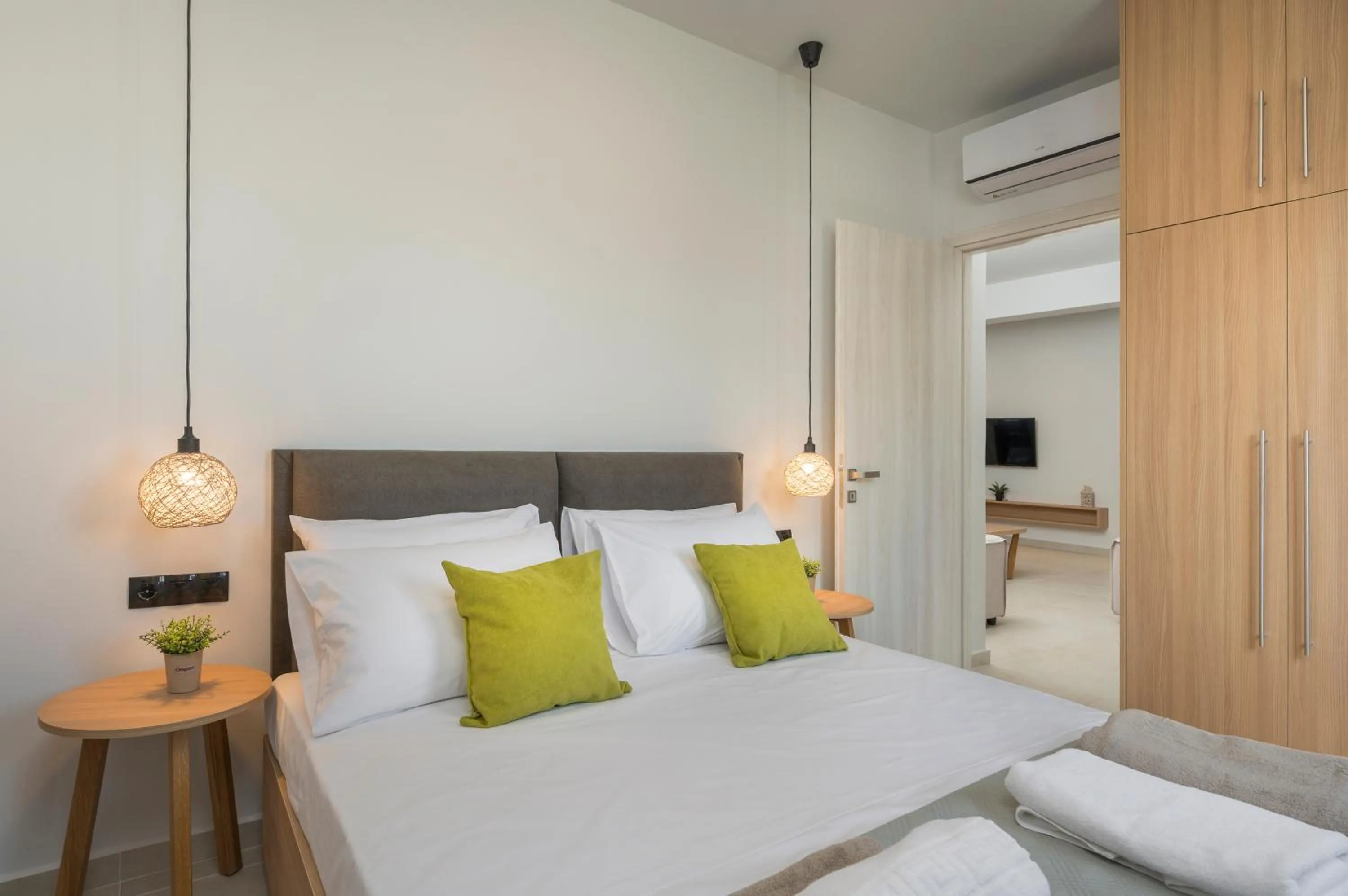 Bed in Aegean Breeze Luxury Apartments next to the sea