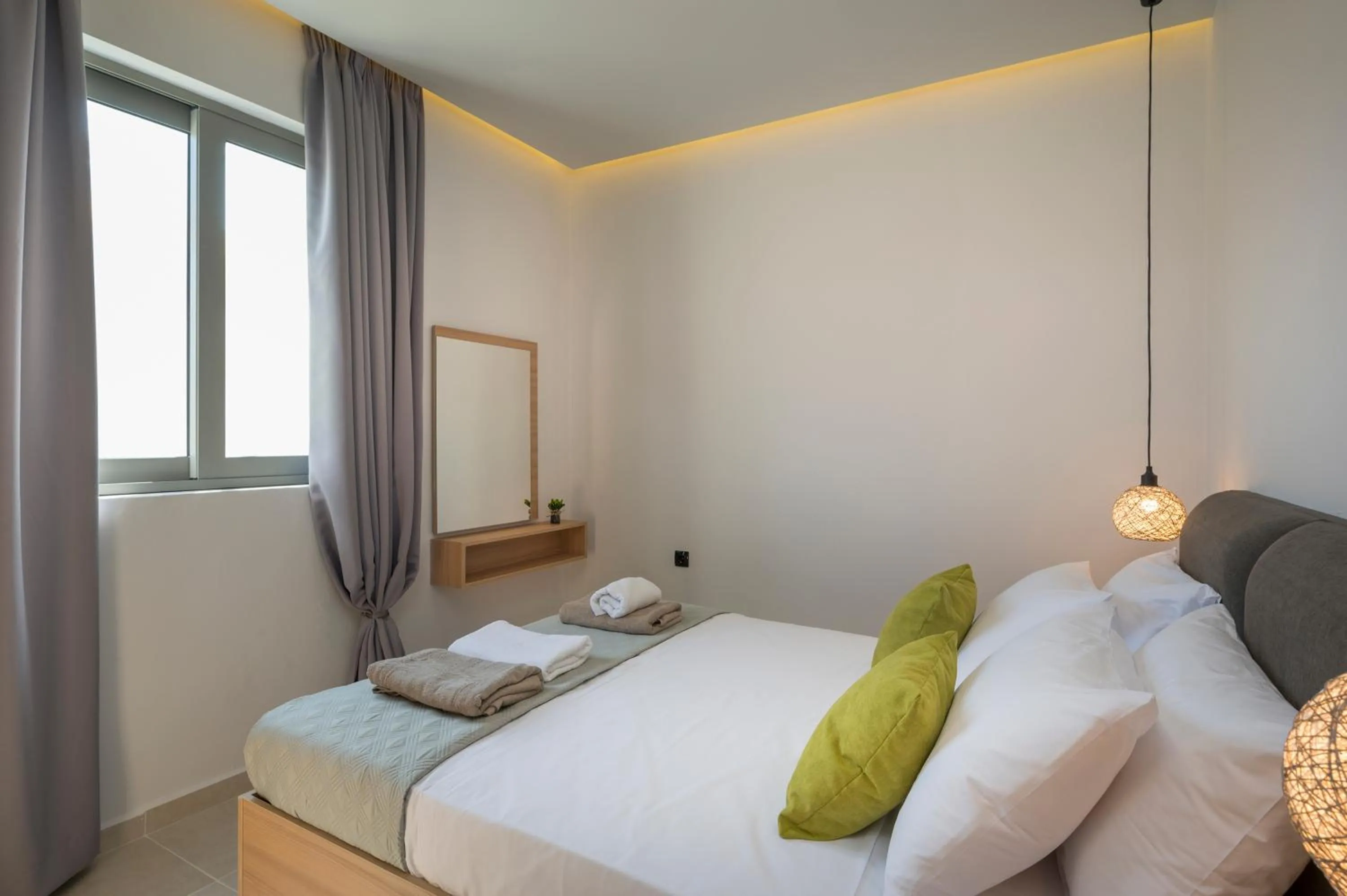 Bed in Aegean Breeze Luxury Apartments next to the sea
