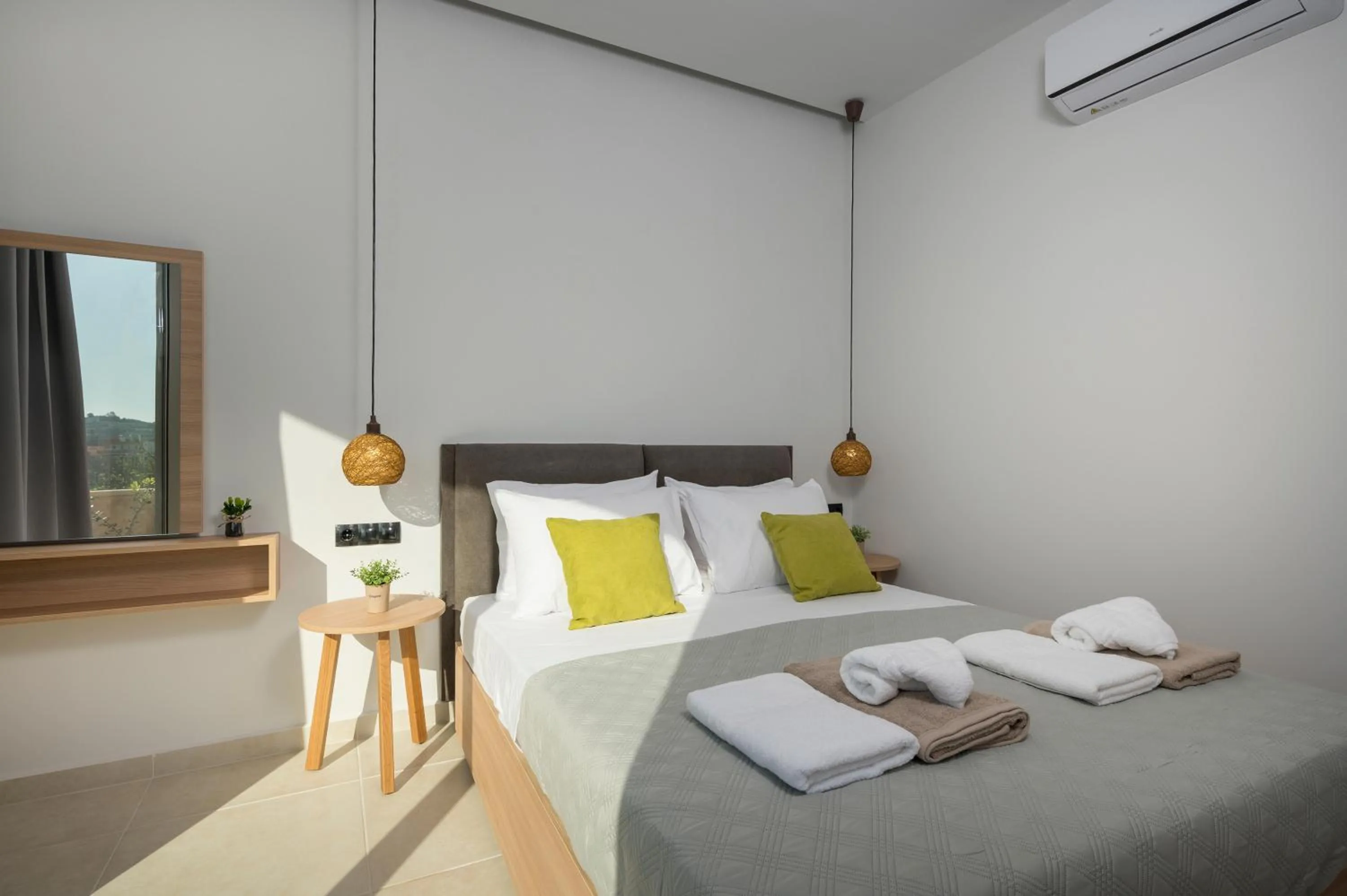 Bed in Aegean Breeze Luxury Apartments next to the sea