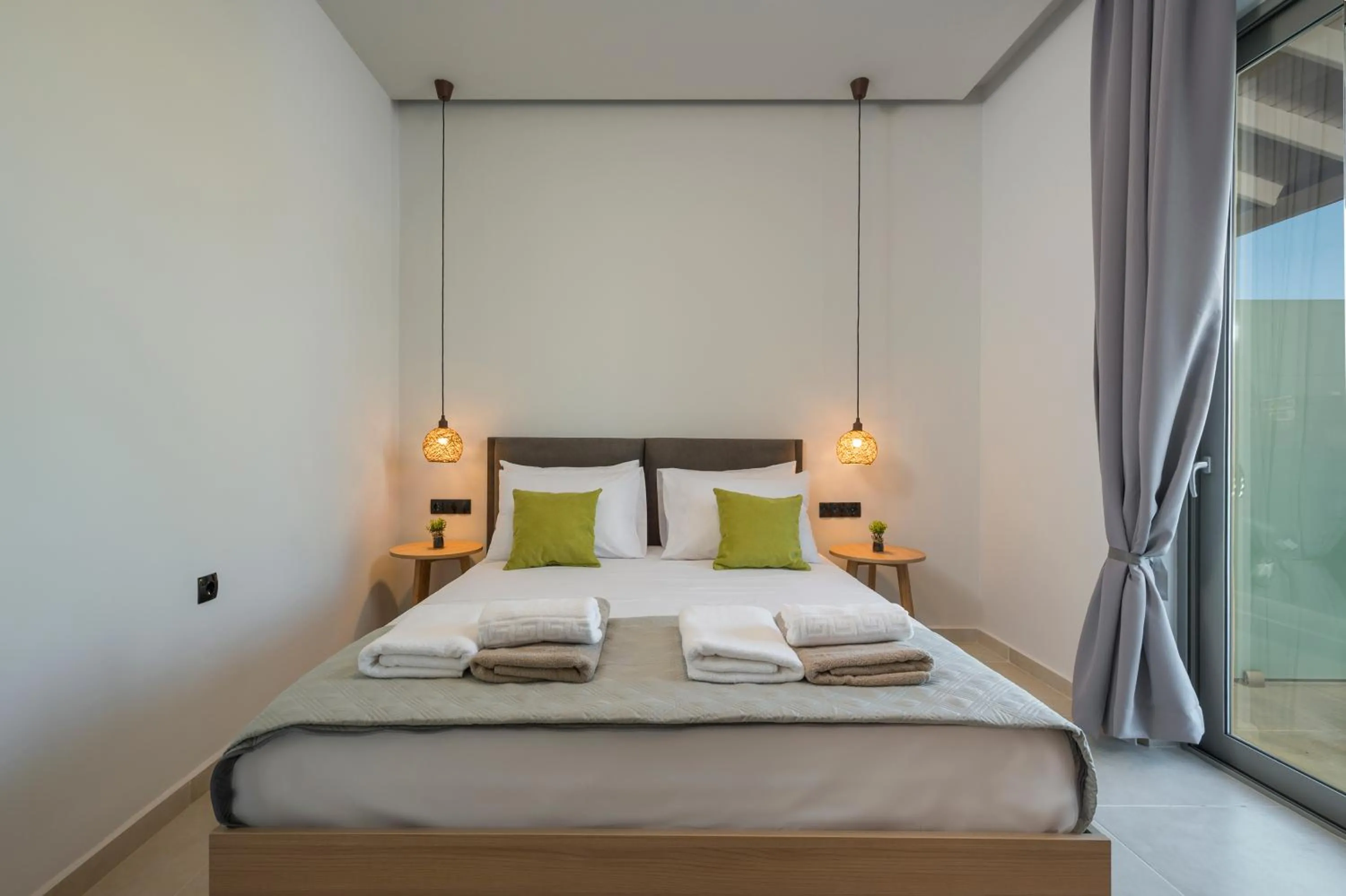 Bed in Aegean Breeze Luxury Apartments next to the sea