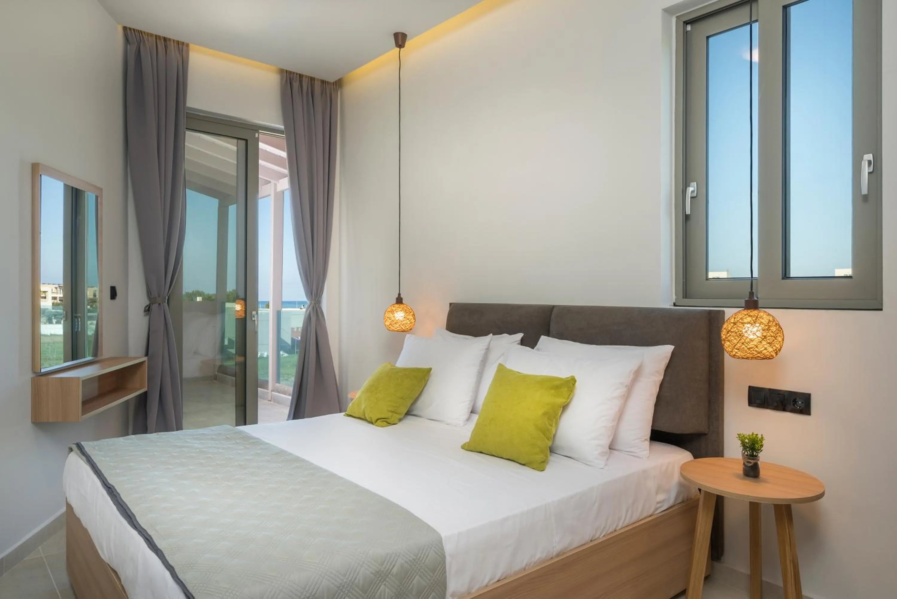 Bed in Aegean Breeze Luxury Apartments next to the sea