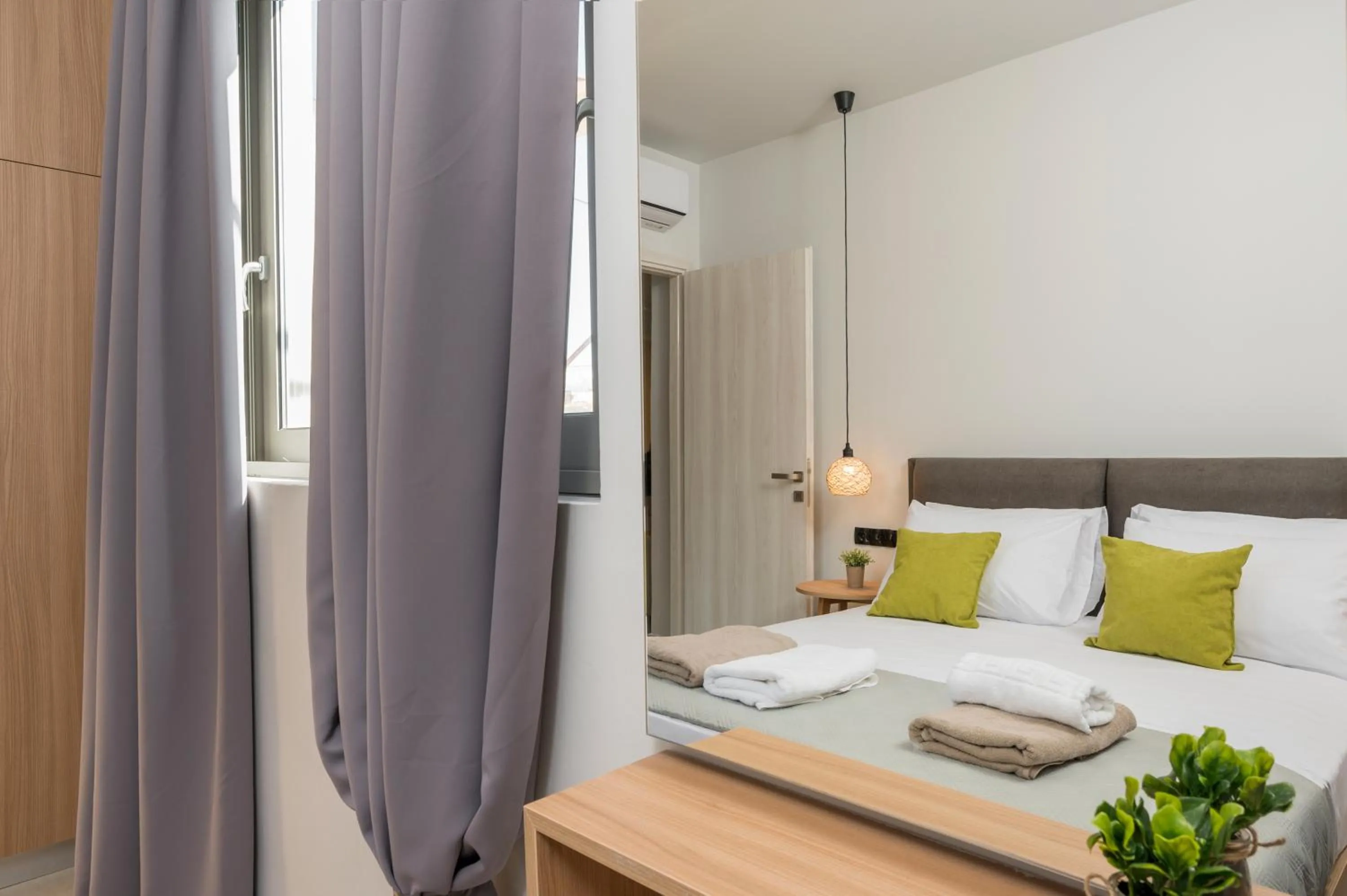 Bed in Aegean Breeze Luxury Apartments next to the sea
