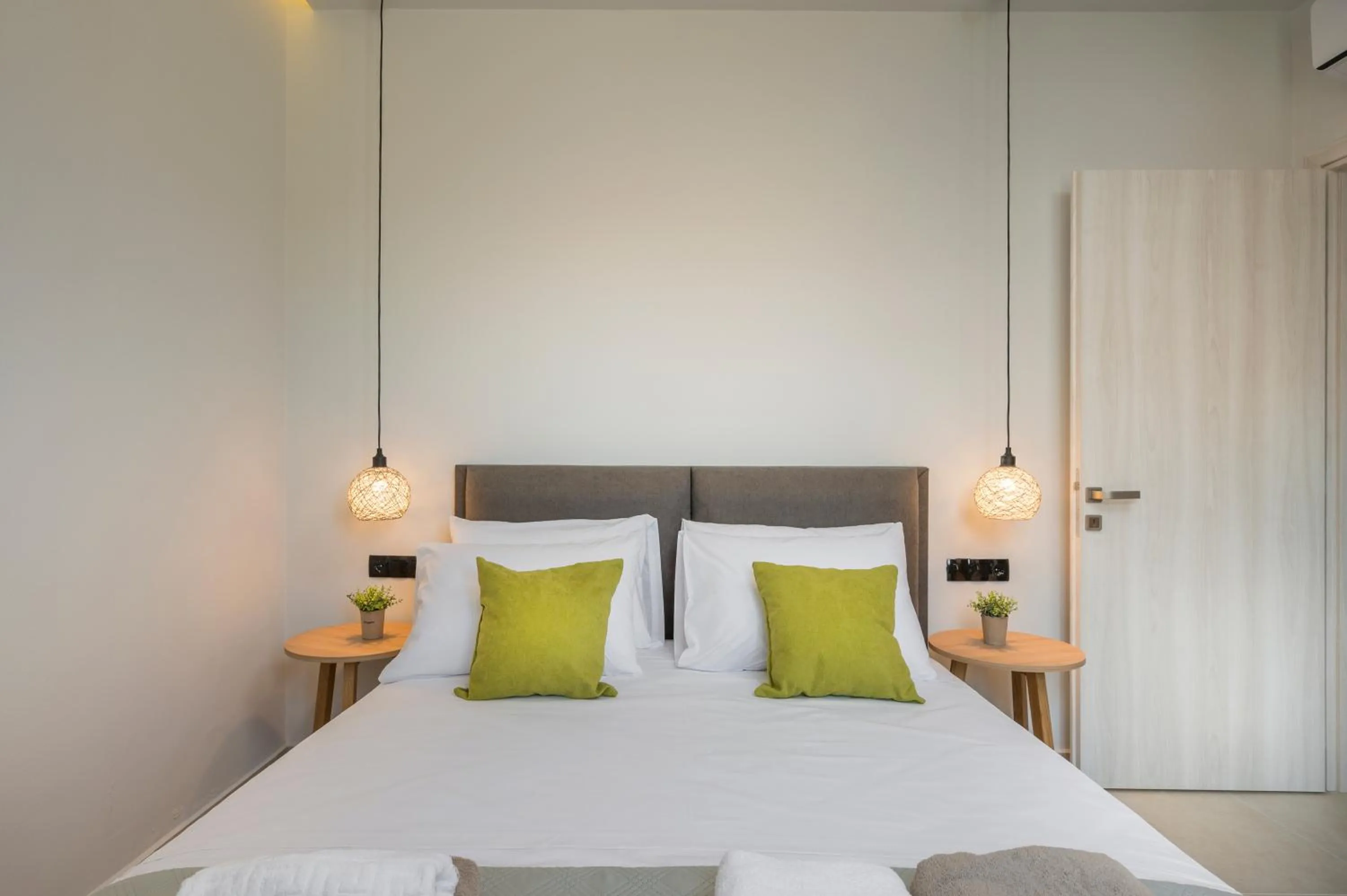 Bed in Aegean Breeze Luxury Apartments next to the sea