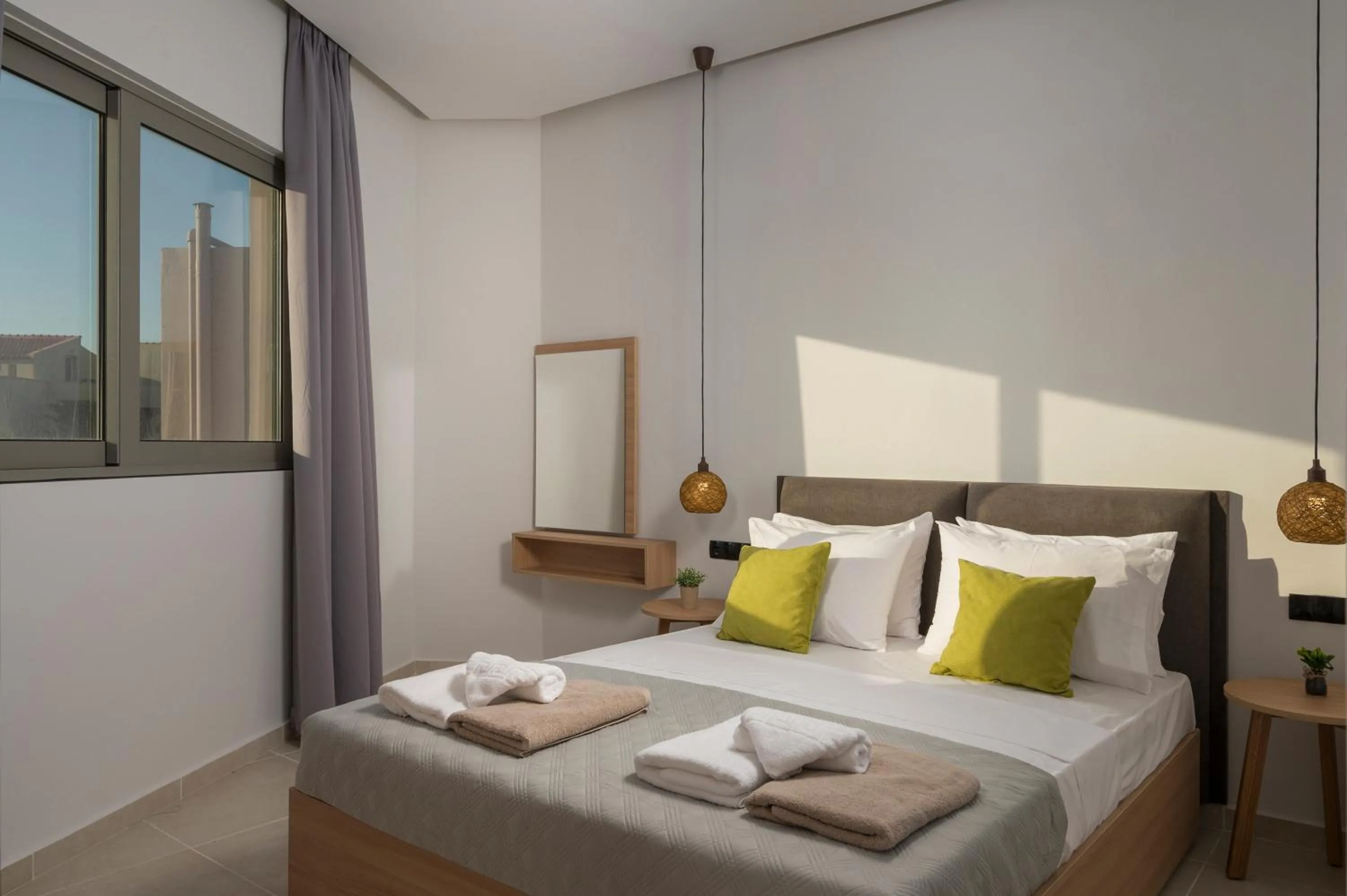Bed in Aegean Breeze Luxury Apartments next to the sea
