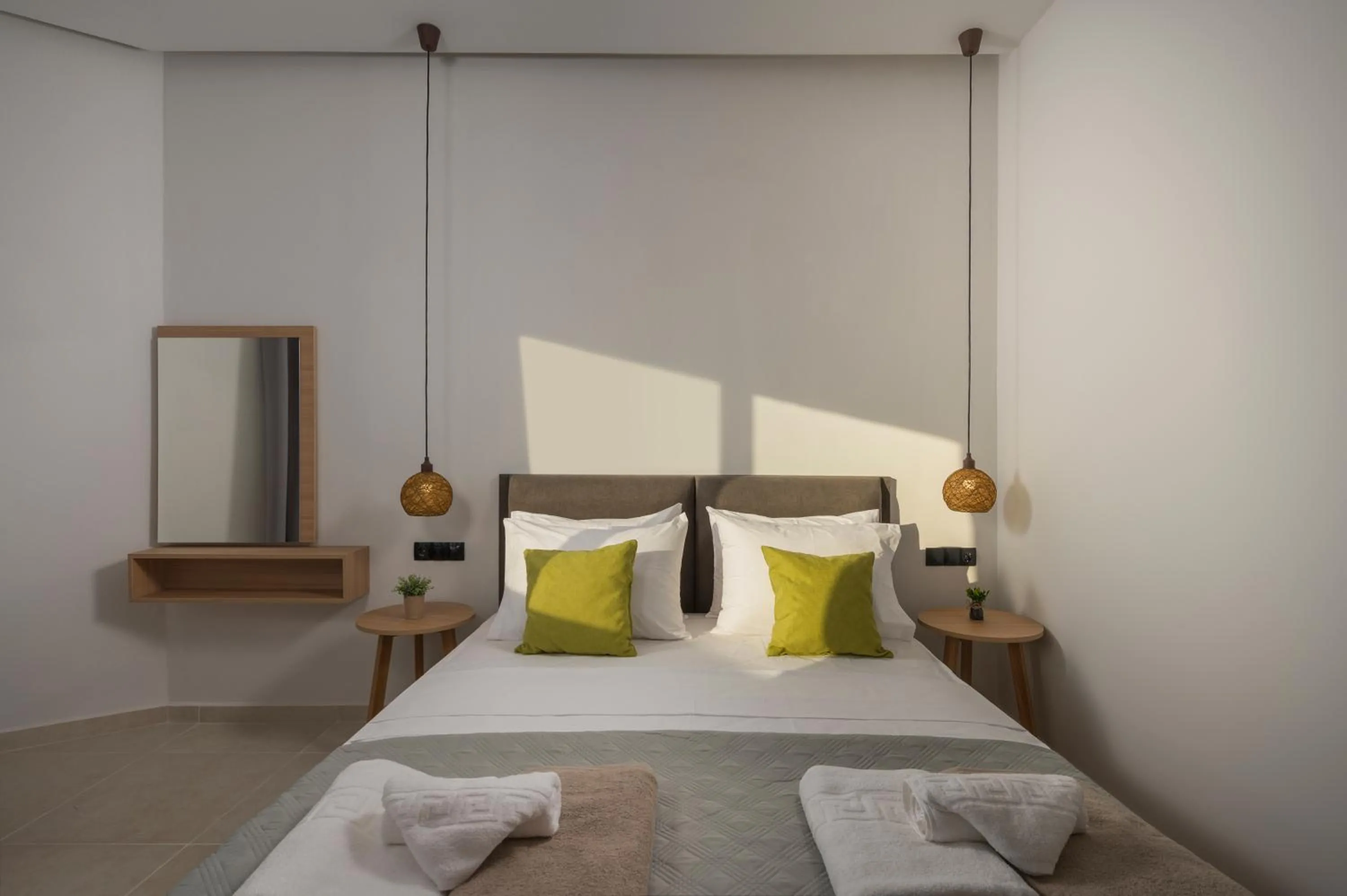 Bed in Aegean Breeze Luxury Apartments next to the sea