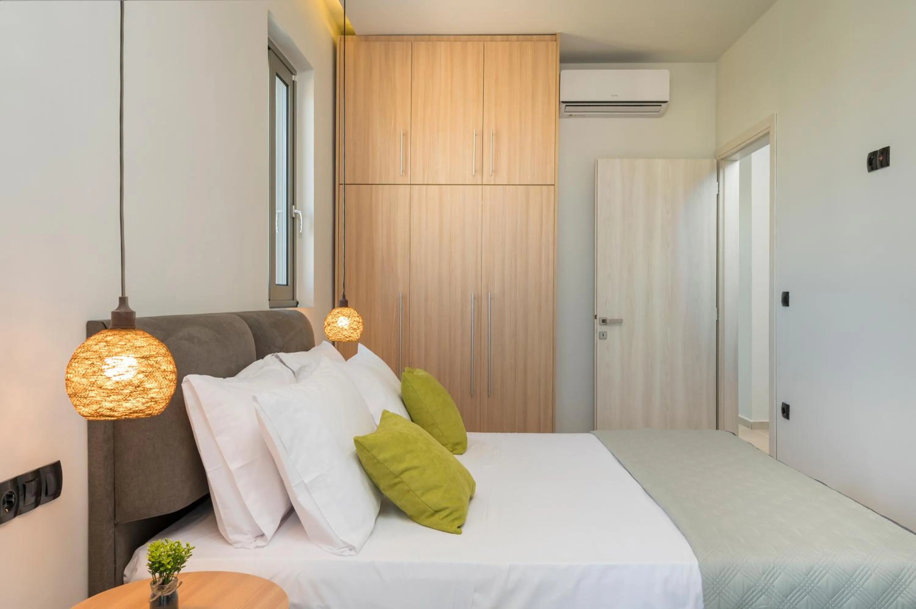 Bed in Aegean Breeze Luxury Apartments next to the sea