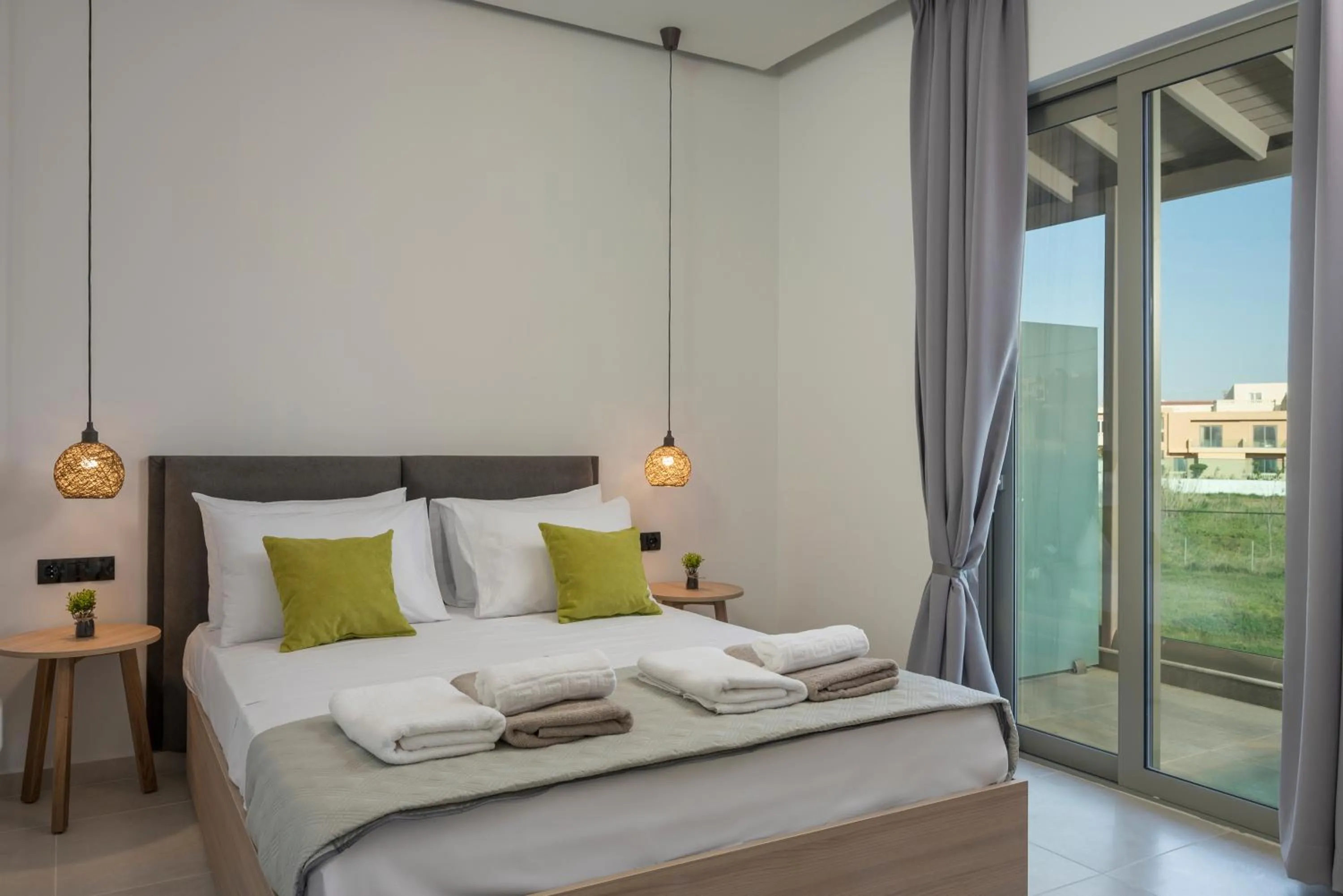 Bed in Aegean Breeze Luxury Apartments next to the sea