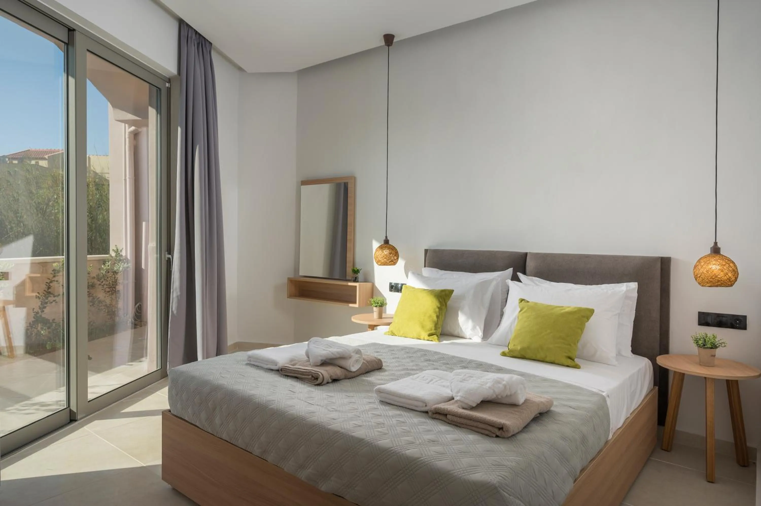 Bed in Aegean Breeze Luxury Apartments next to the sea