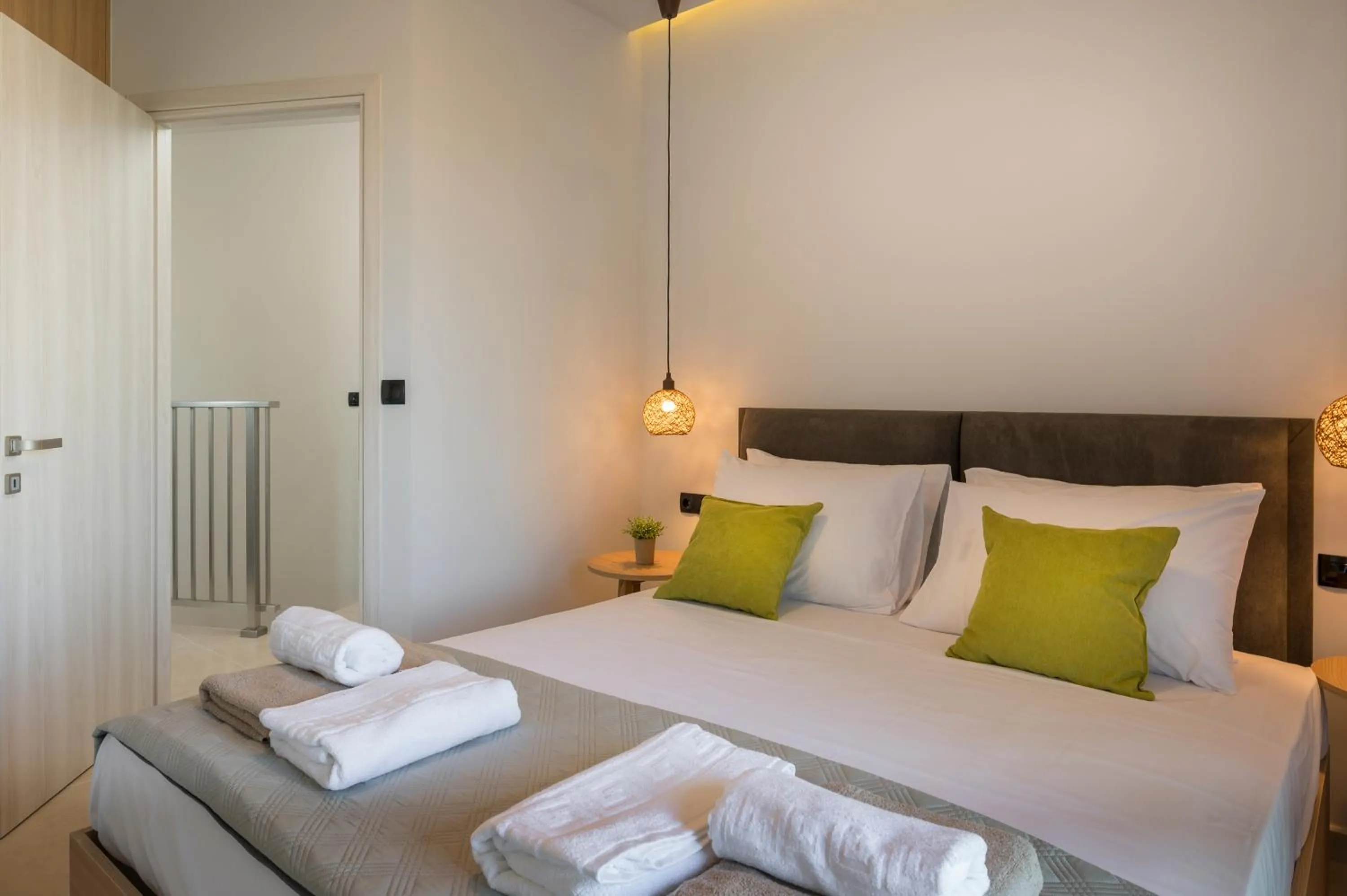 Bed in Aegean Breeze Luxury Apartments next to the sea