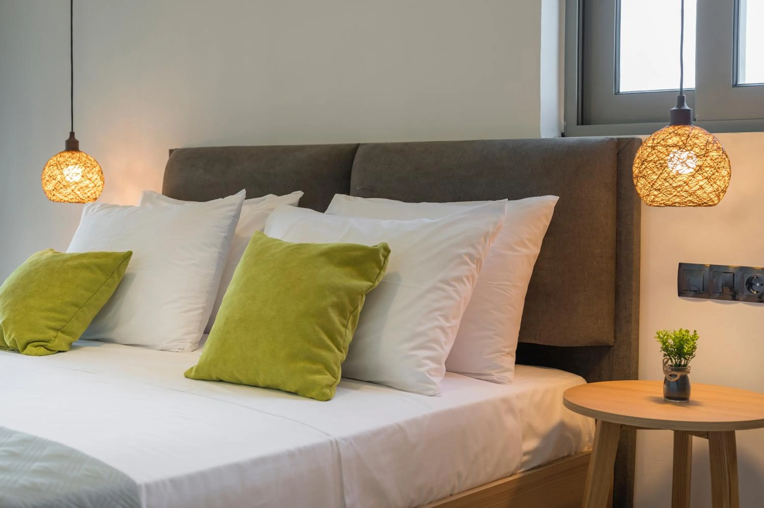 Bed in Aegean Breeze Luxury Apartments next to the sea