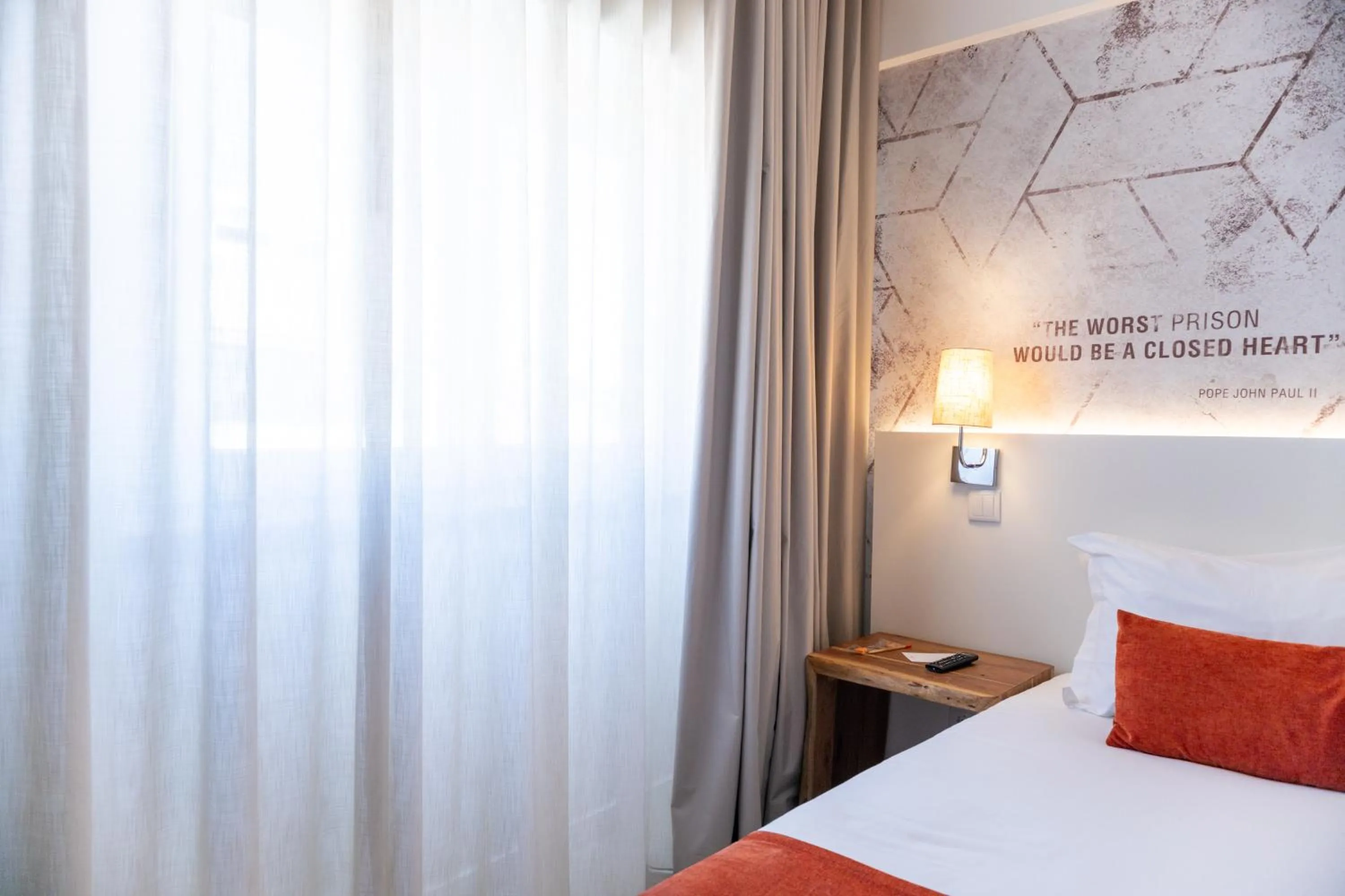 Bed in The ICONS Lisbon Hotel