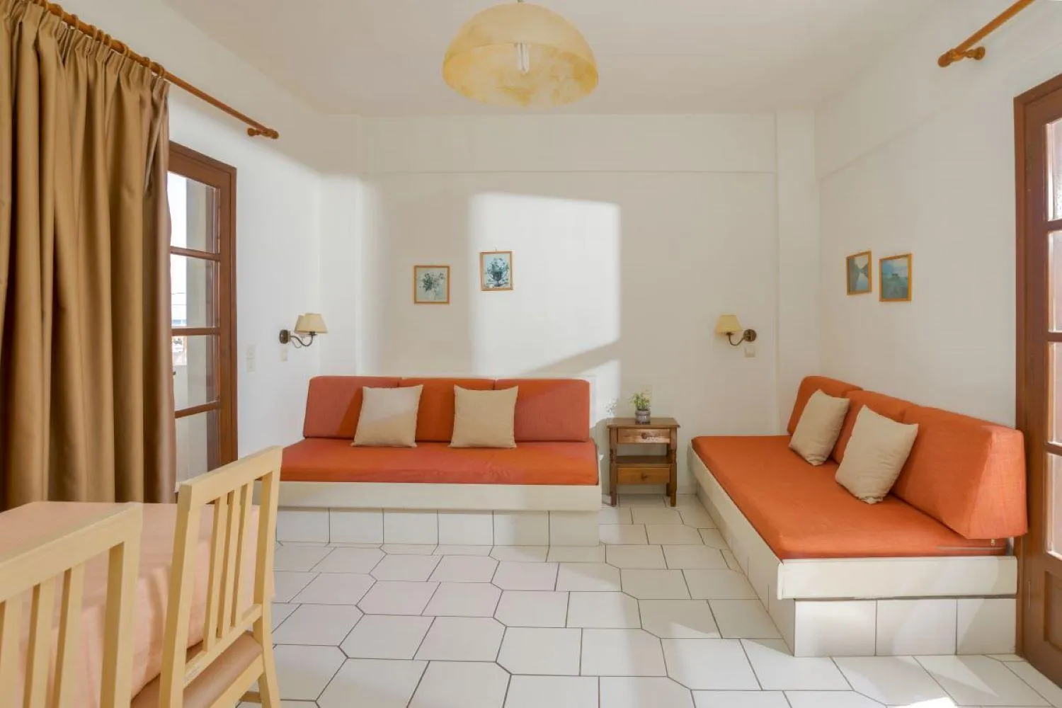 Seating area in John Mary Apartments by Estia