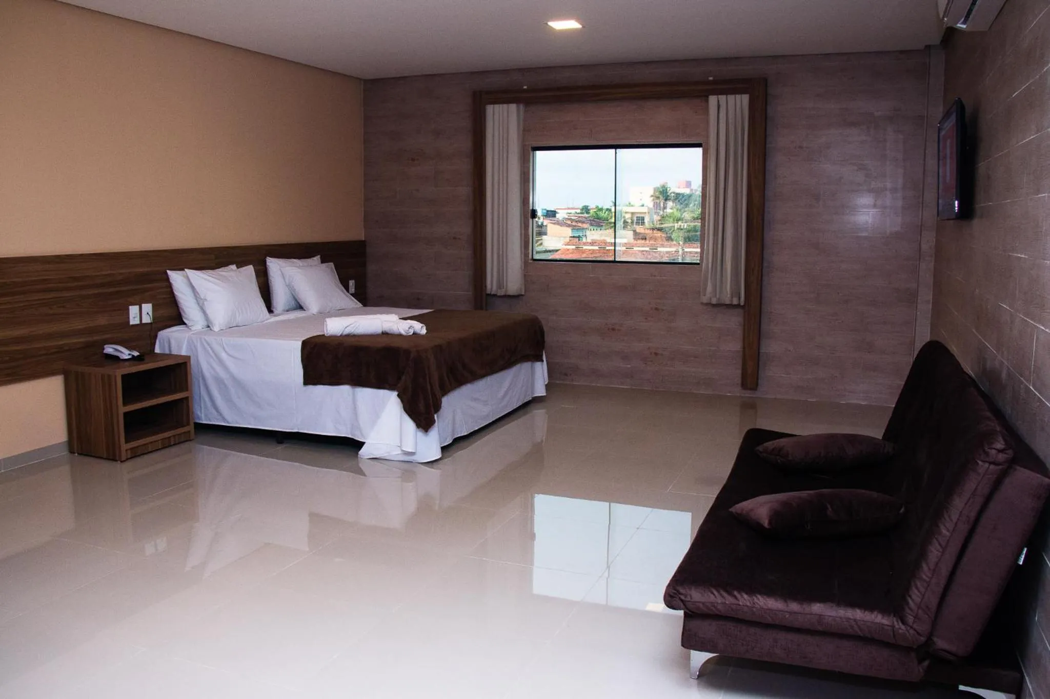 Bed in INACIO'S PLAZA HOTEL