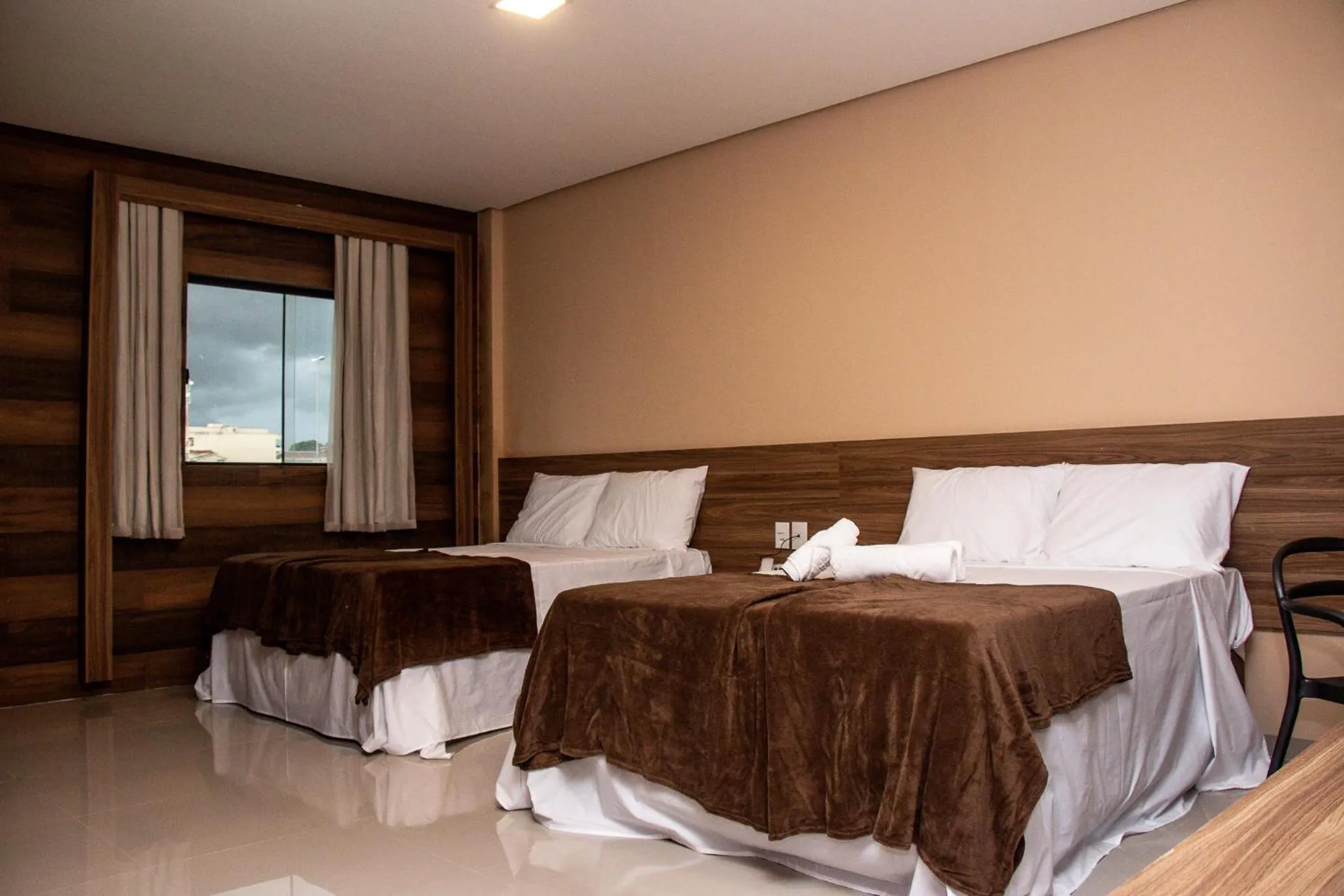 Bed in INACIO'S PLAZA HOTEL