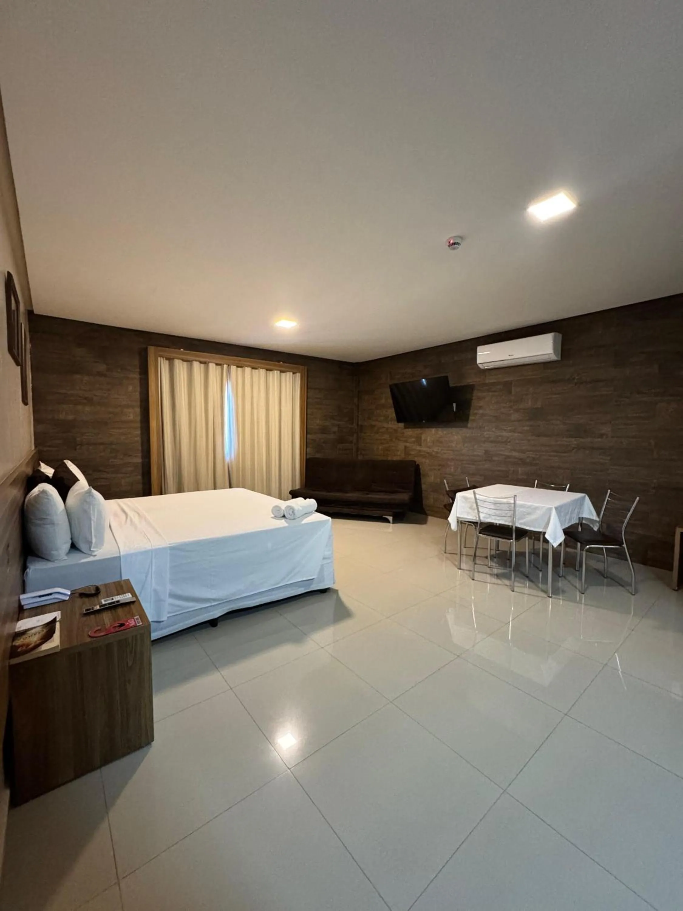 Bed in INACIO'S PLAZA HOTEL