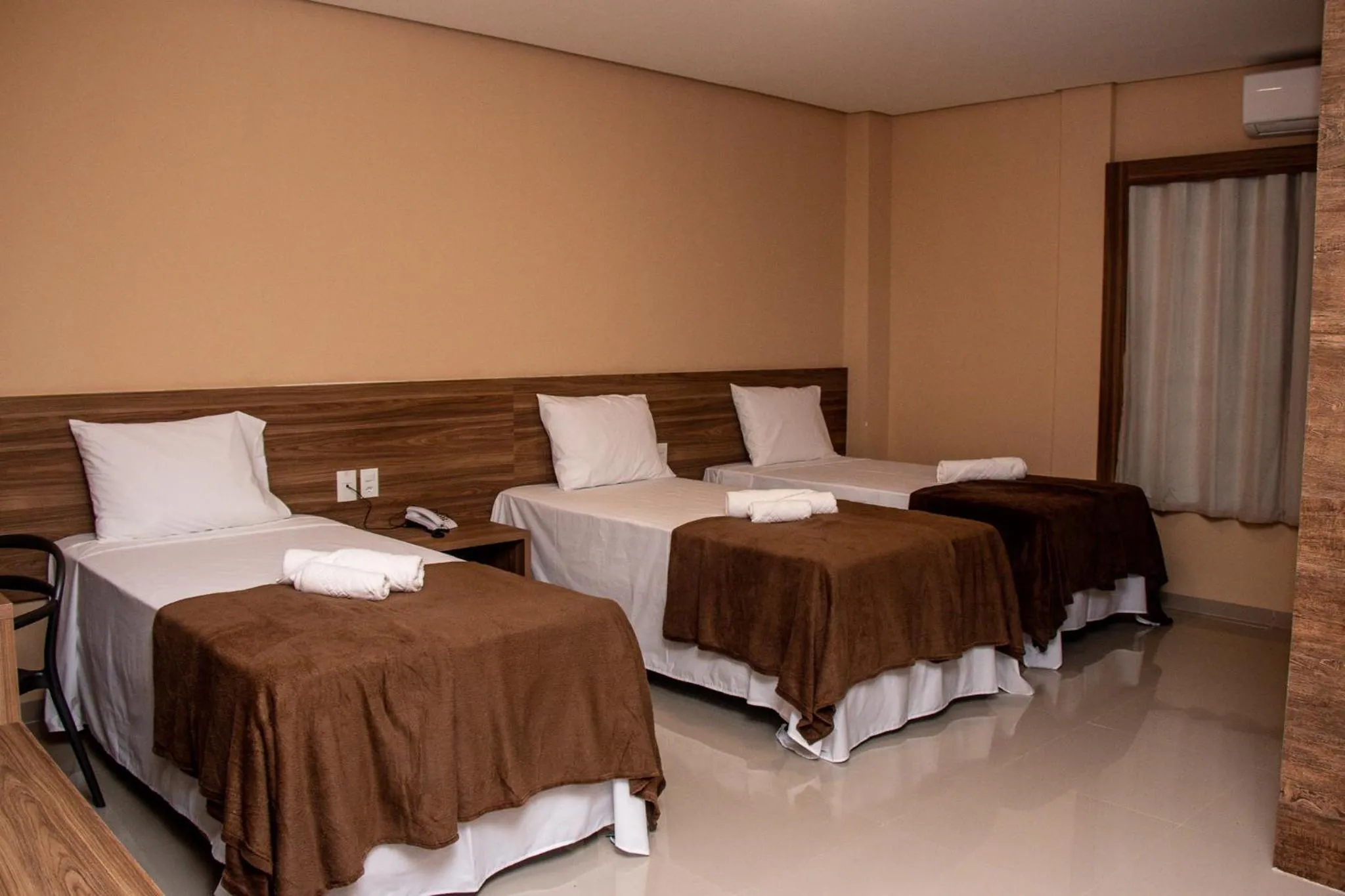 Bed in INACIO'S PLAZA HOTEL