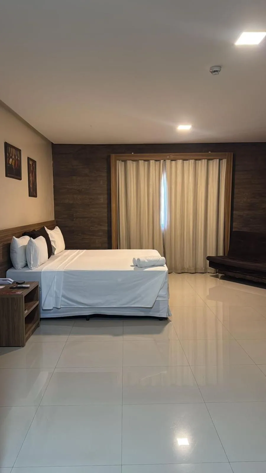 Bed in INACIO'S PLAZA HOTEL