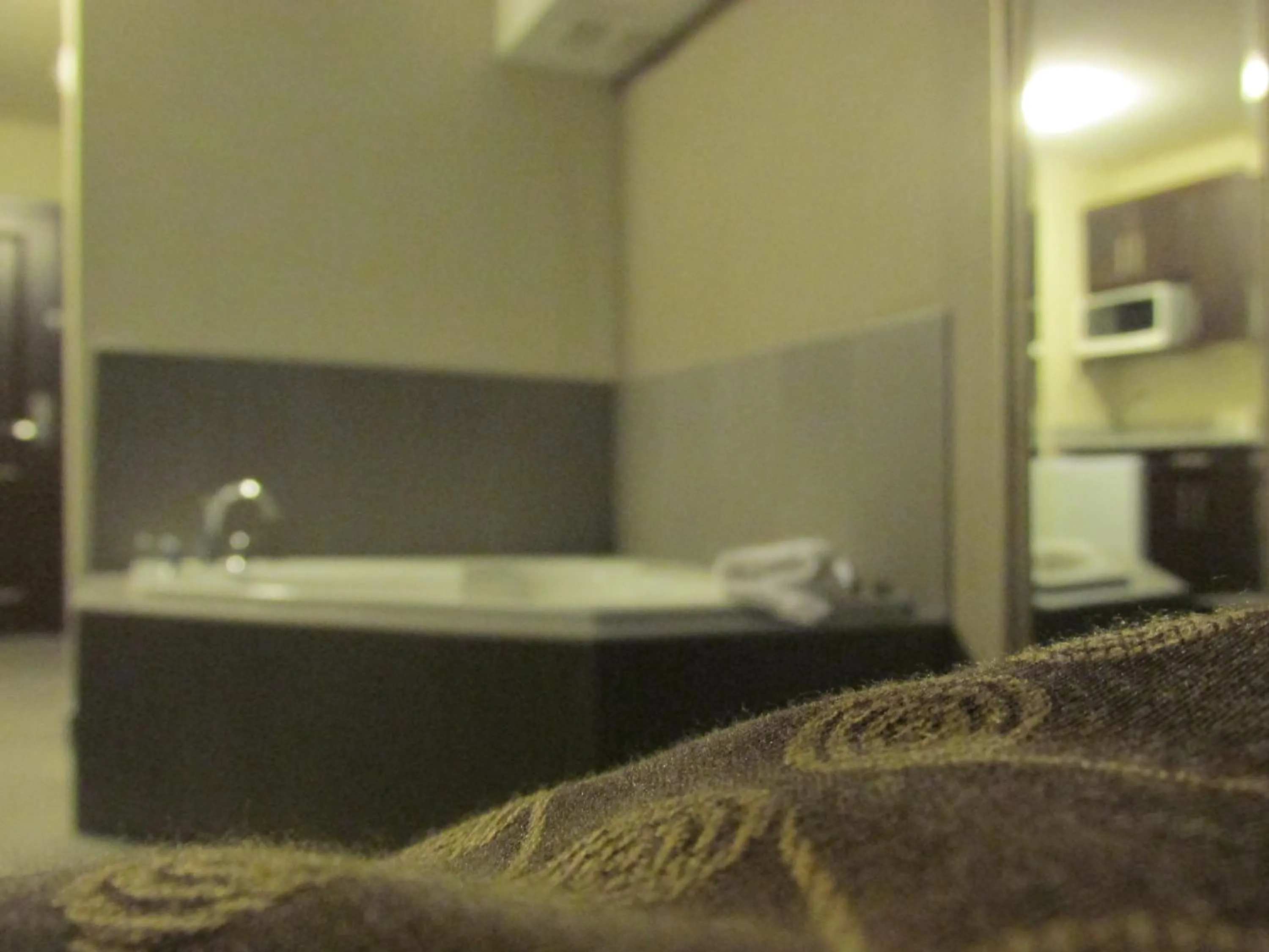 Bed in Sigma Inn & Suites