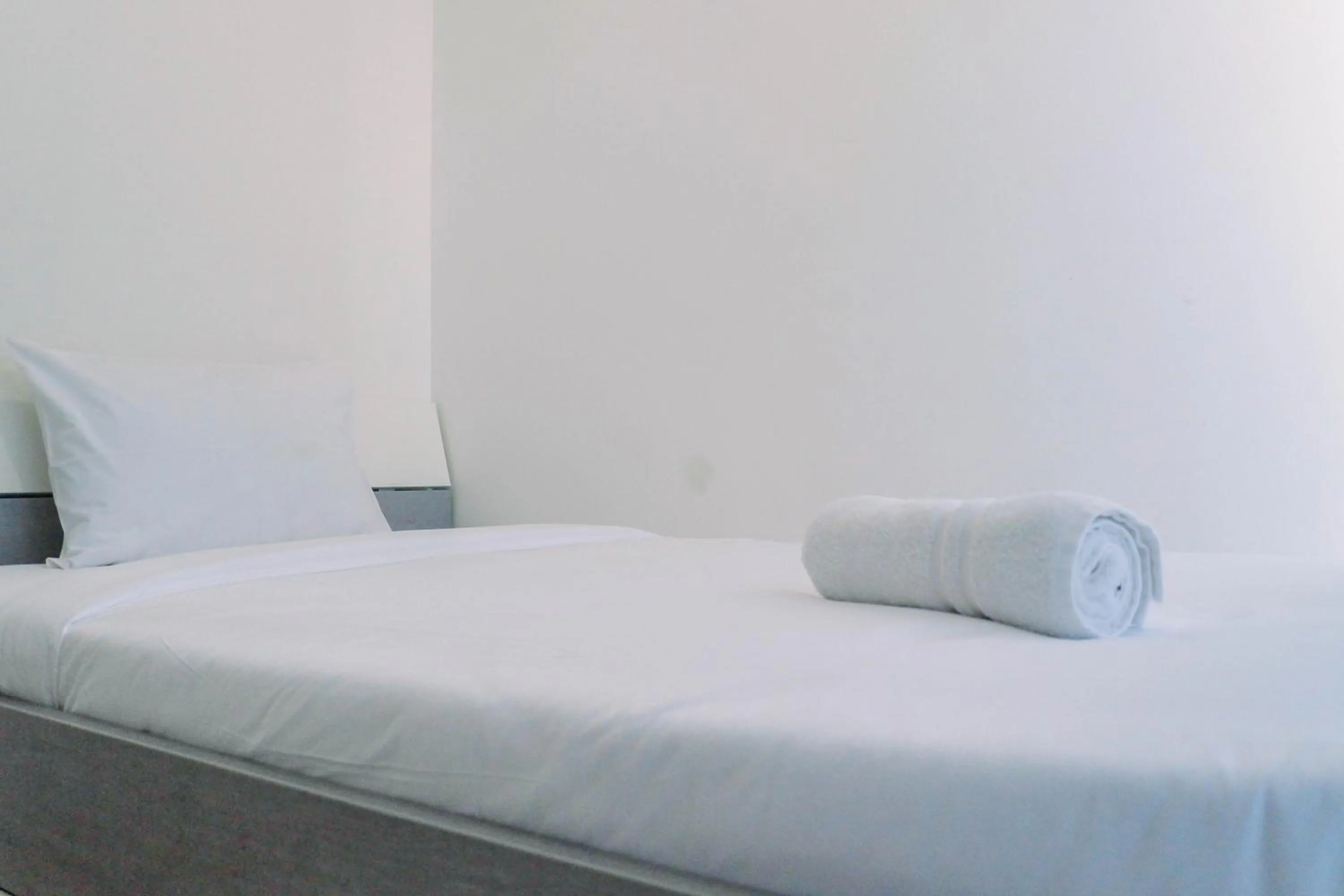 Bed in Lavish 2BR Apartment at Grand Sungkono Lagoon By Travelio