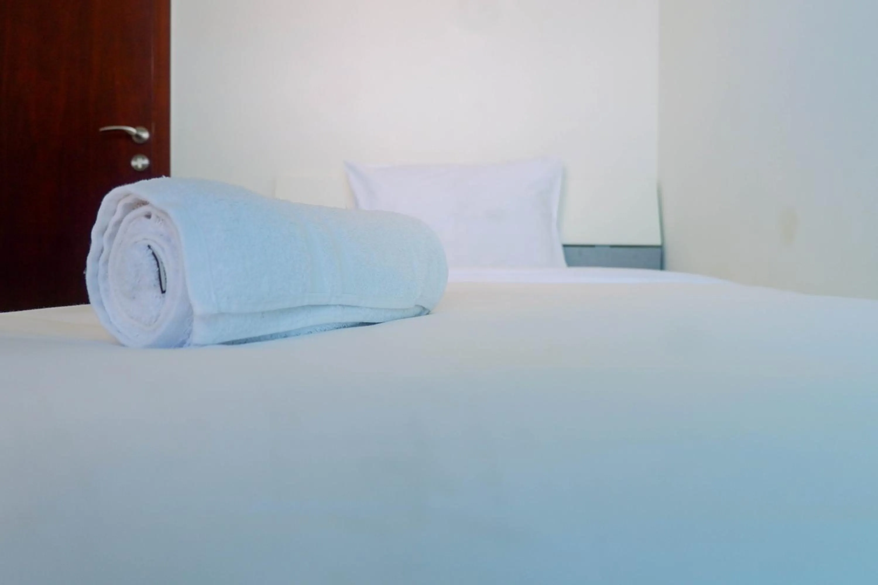 Bed in Lavish 2BR Apartment at Grand Sungkono Lagoon By Travelio