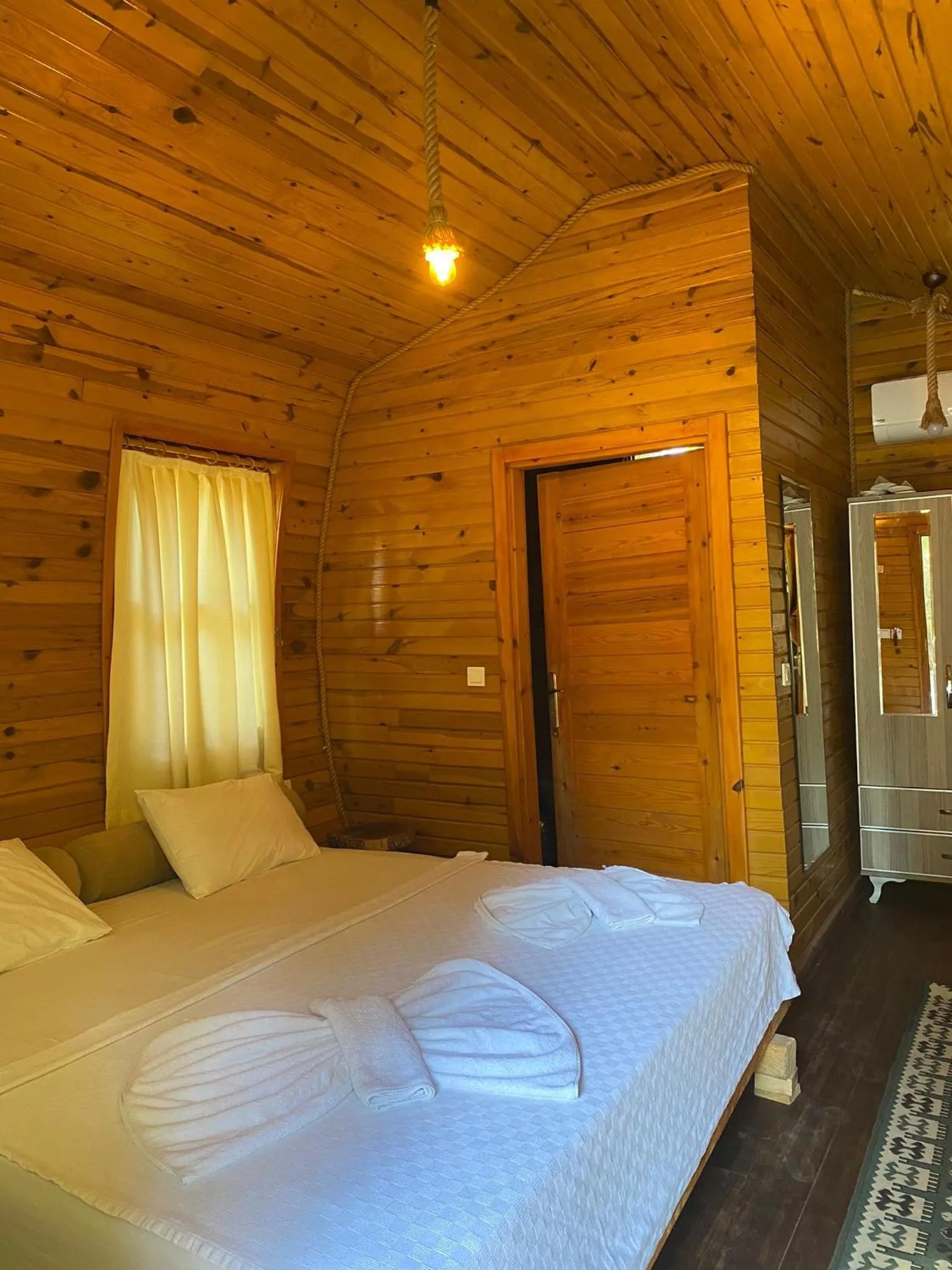 Bed in Green Pine Bungalows & Beach Luxury Concept