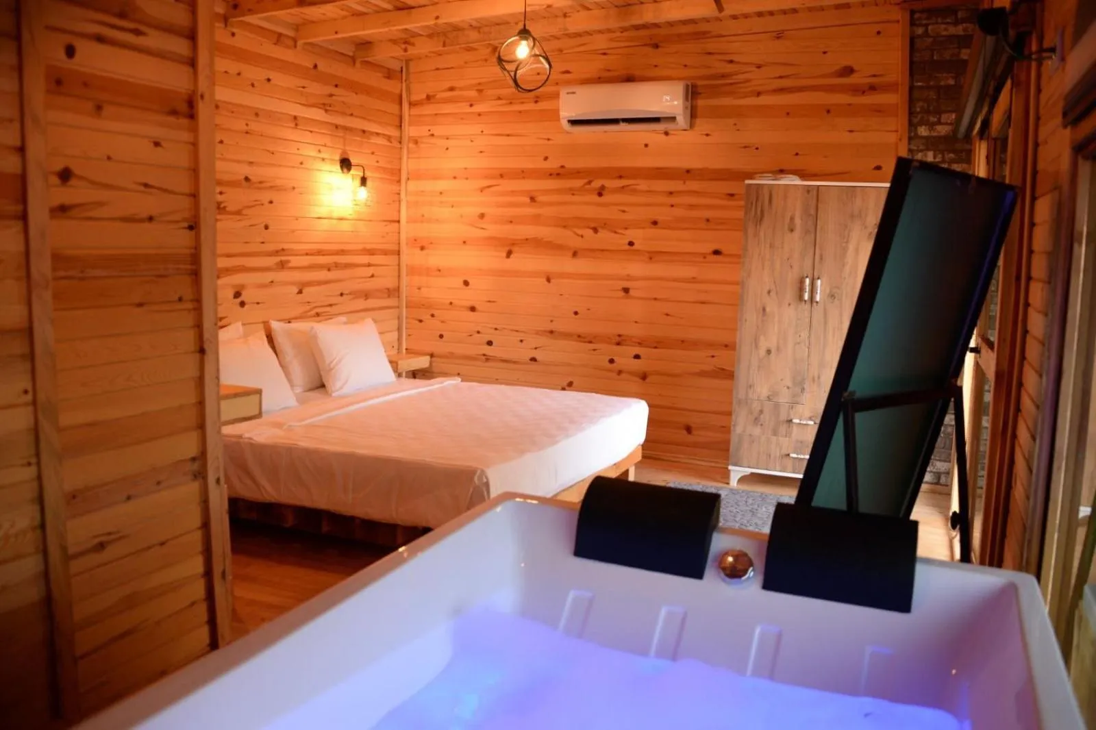 Bed in Green Pine Bungalows & Beach Luxury Concept