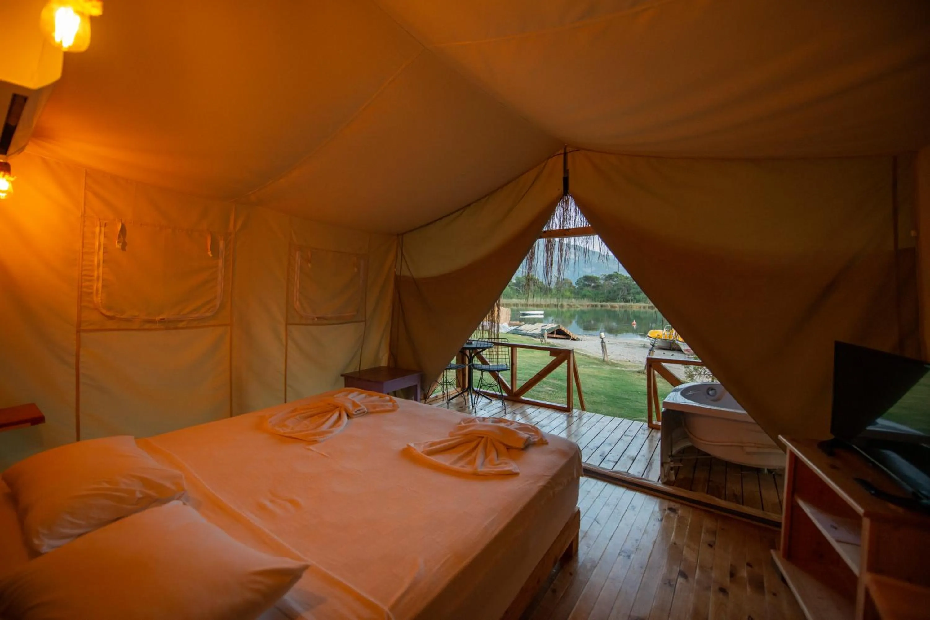 Bed in Green Pine Bungalows & Beach Luxury Concept