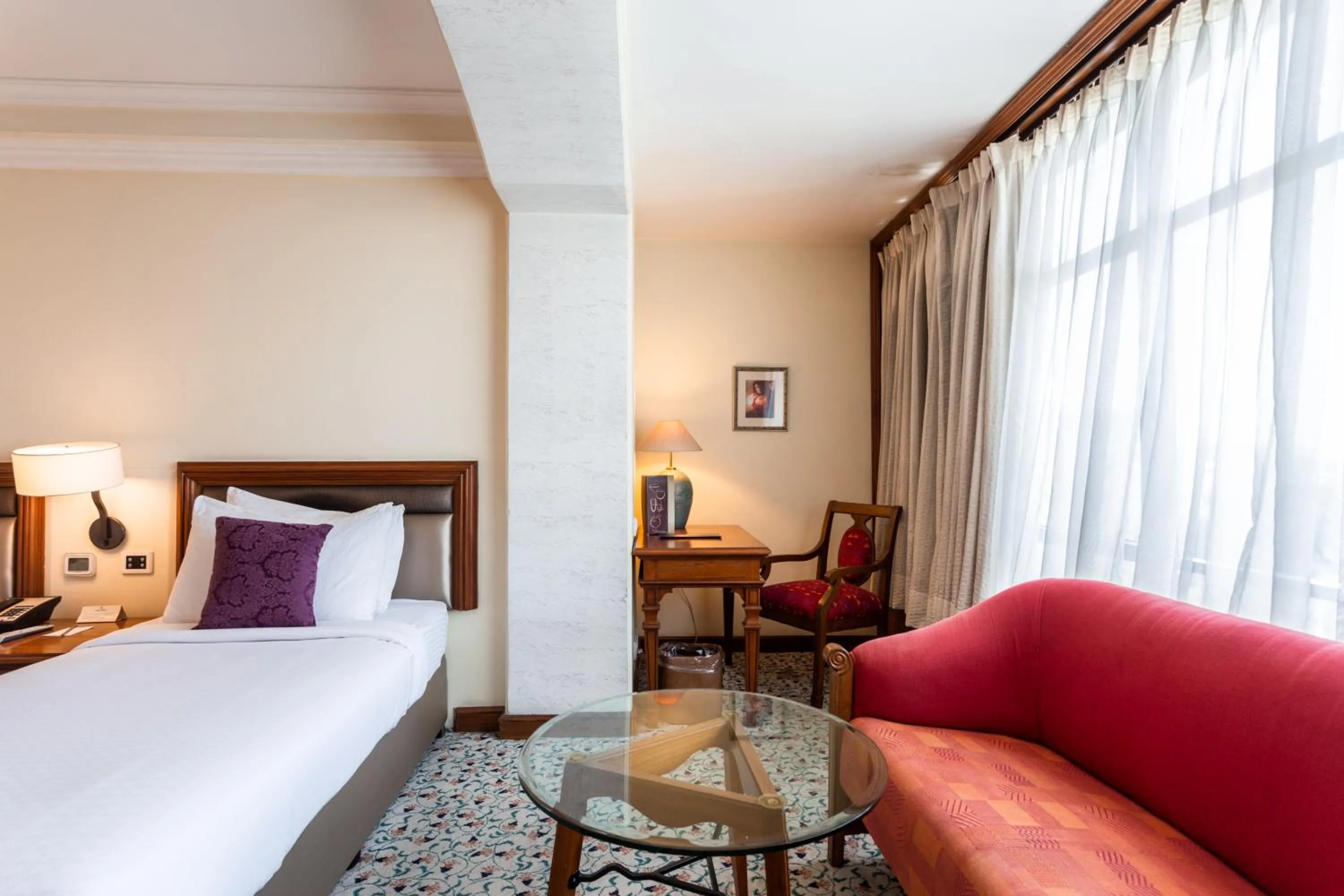 Seating area, Bed in The Maya Hotel