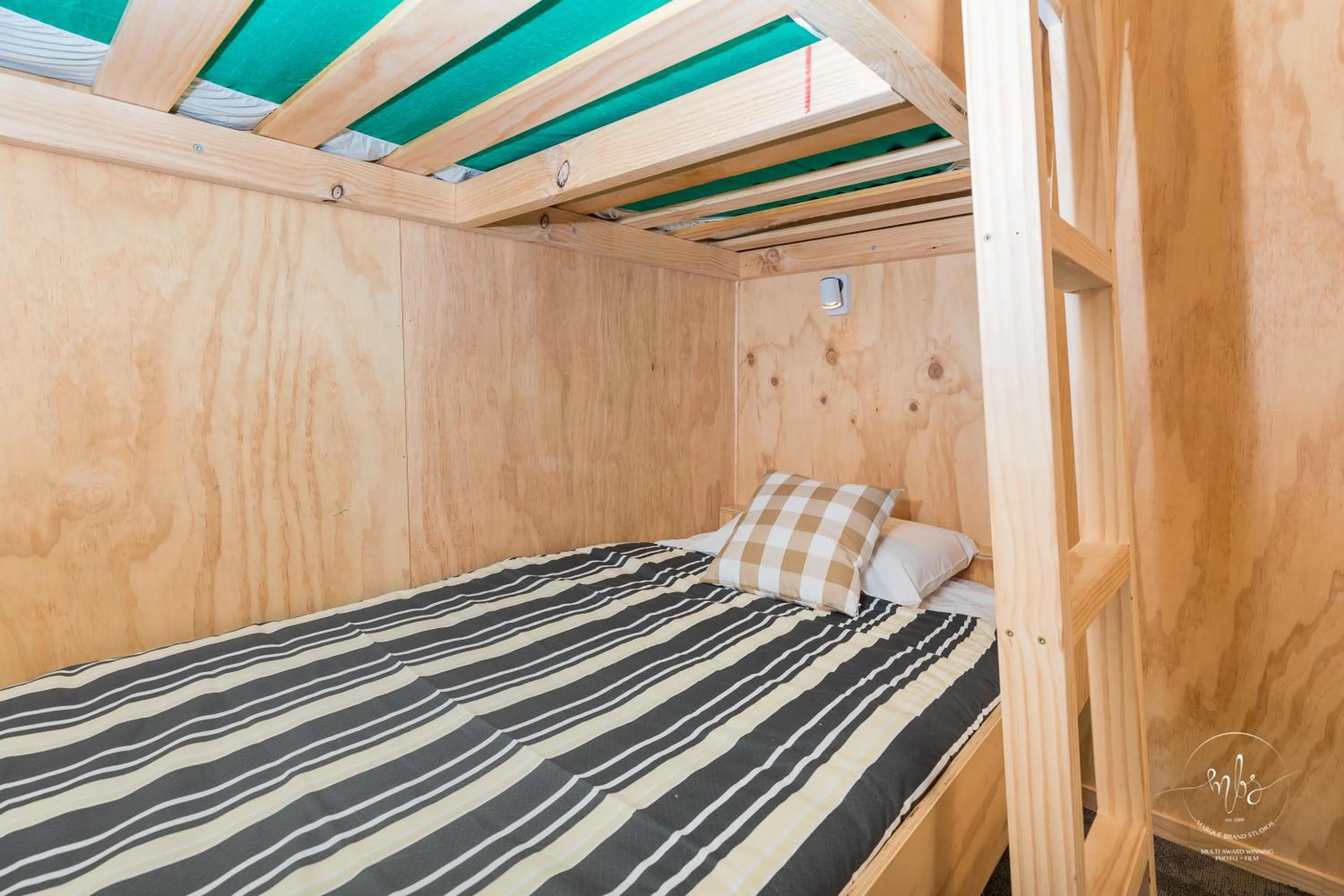Bed in Waitomo Homestead Cabins