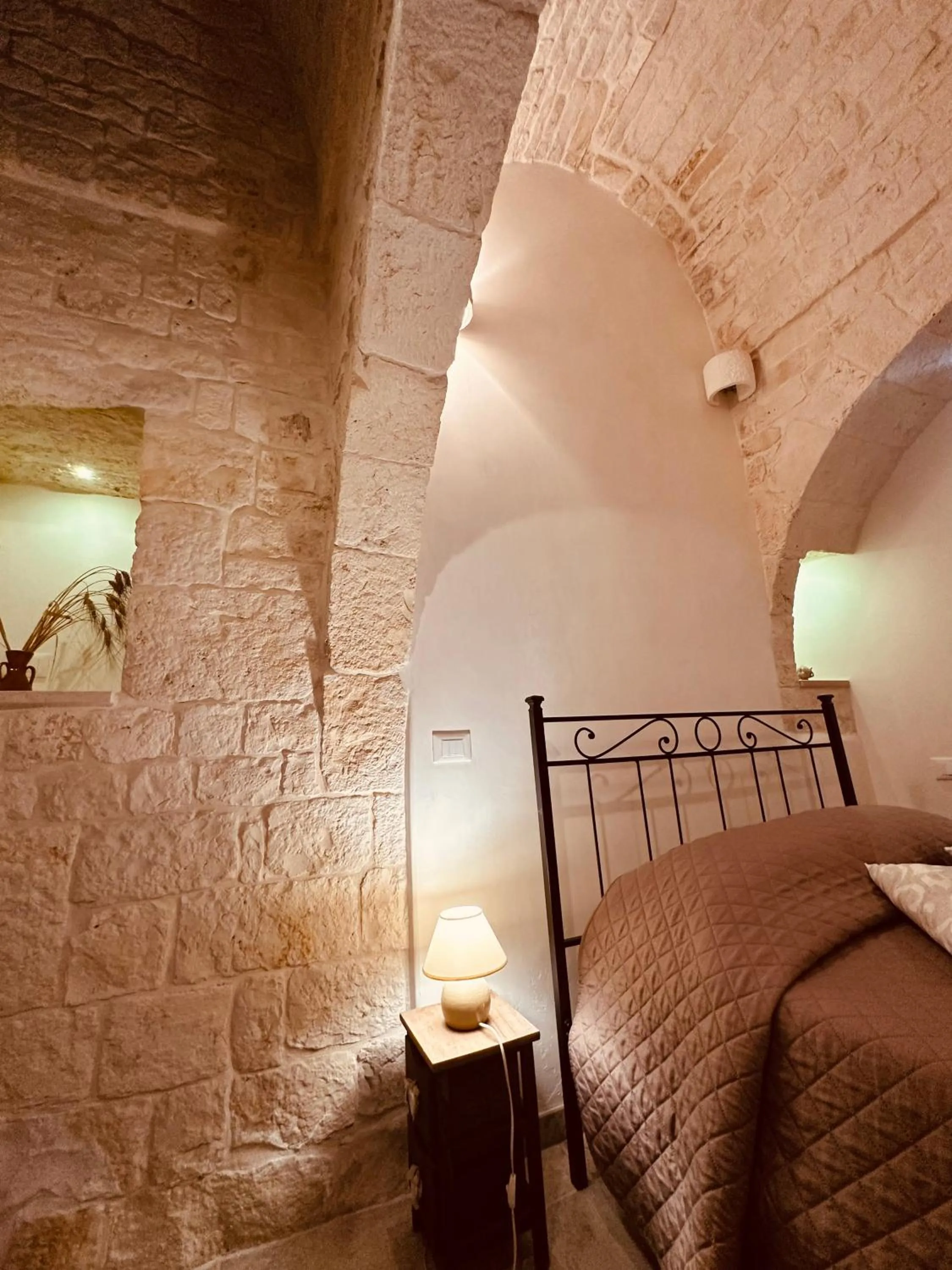 Bed in Pietra Rosa Apulian Home