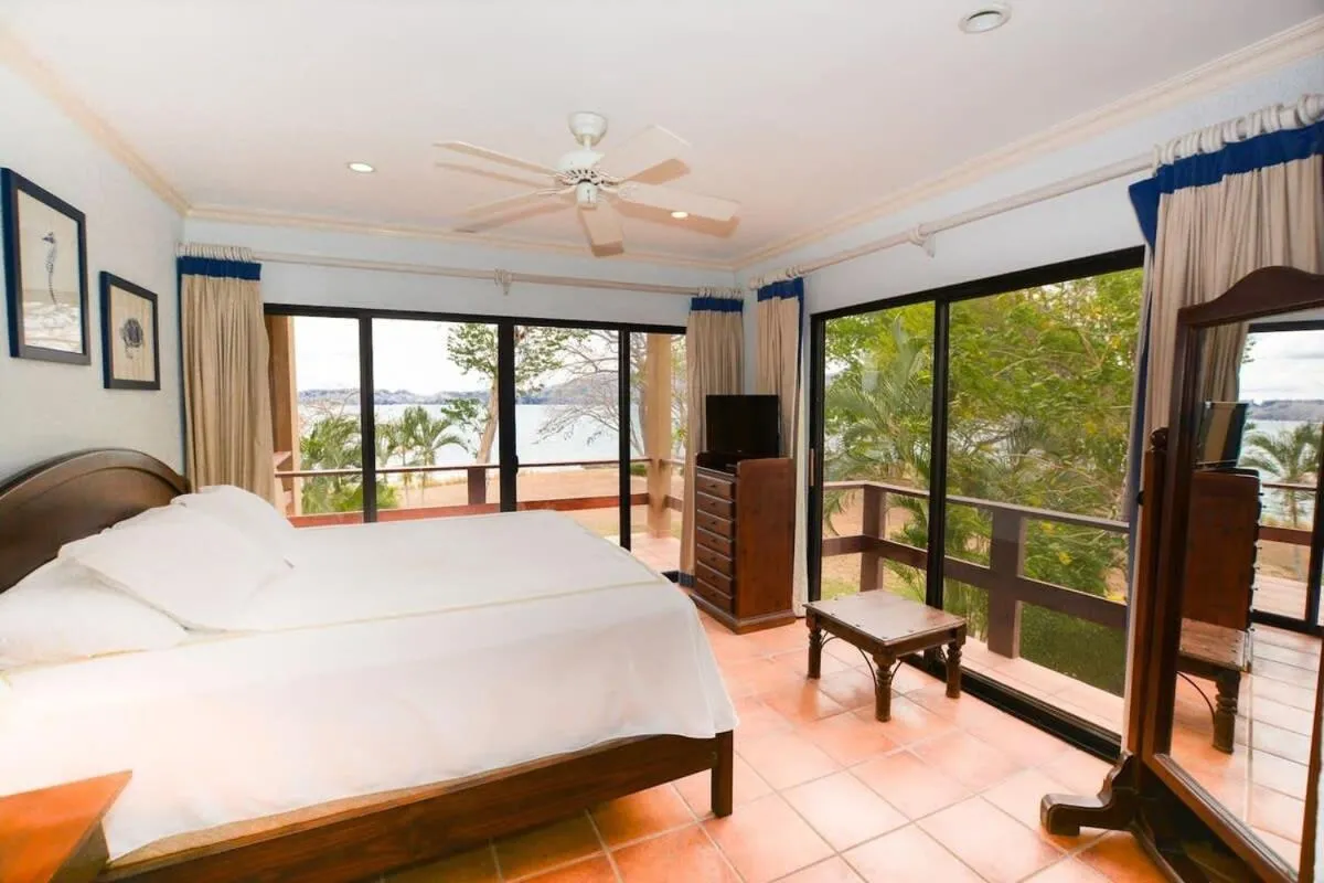 Bed in Elegant 3BR Beachfront Condo with Spacious Interior, Ocean-View Terrace & Direct Access to Playa Flamingo