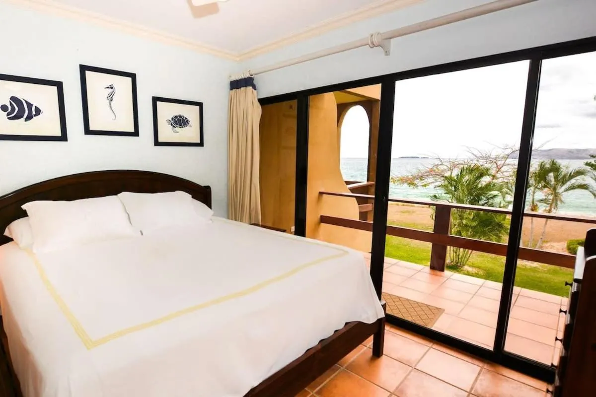Bed in Elegant 3BR Beachfront Condo with Spacious Interior, Ocean-View Terrace & Direct Access to Playa Flamingo