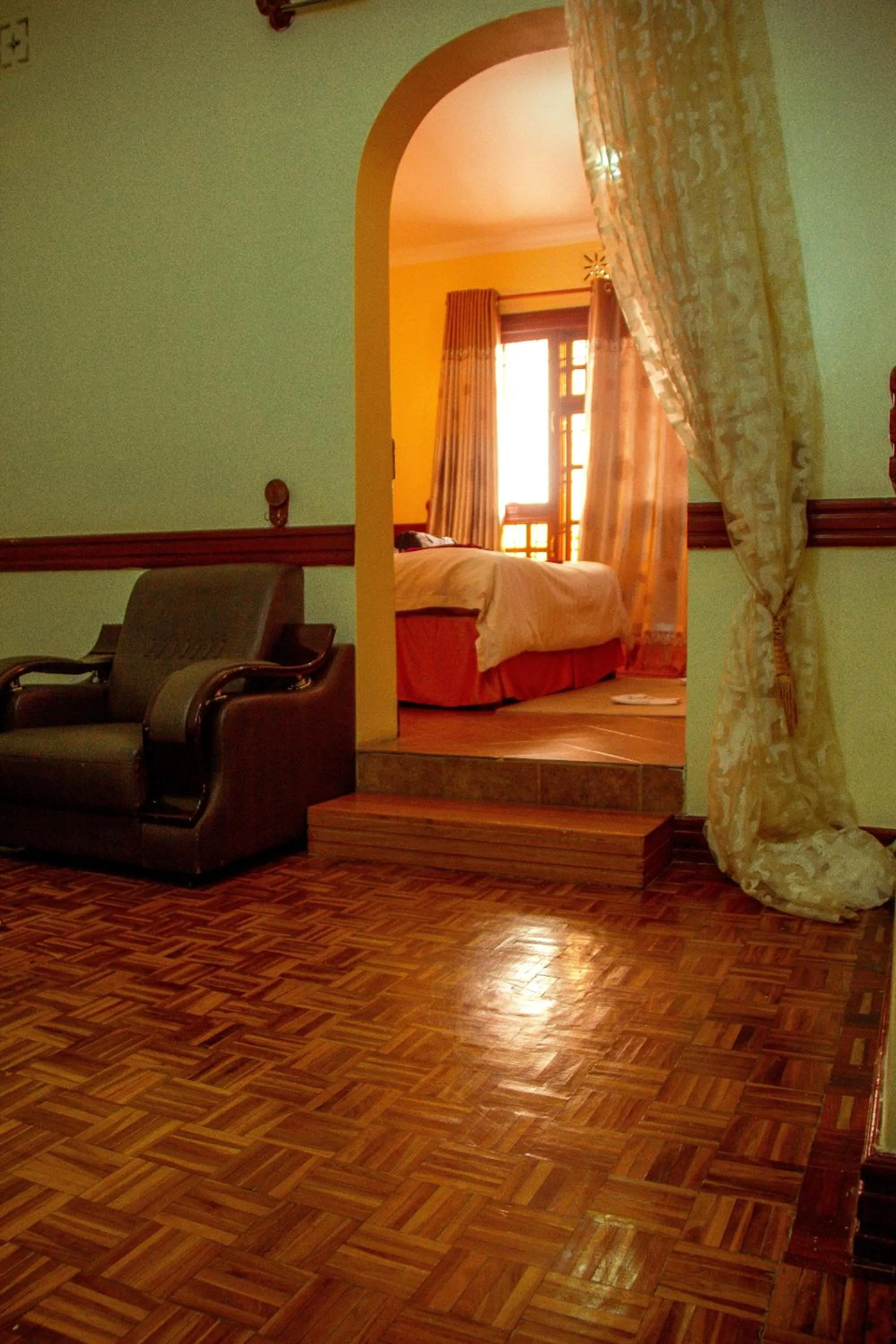 Living room, Bed in New Charity Hotel International