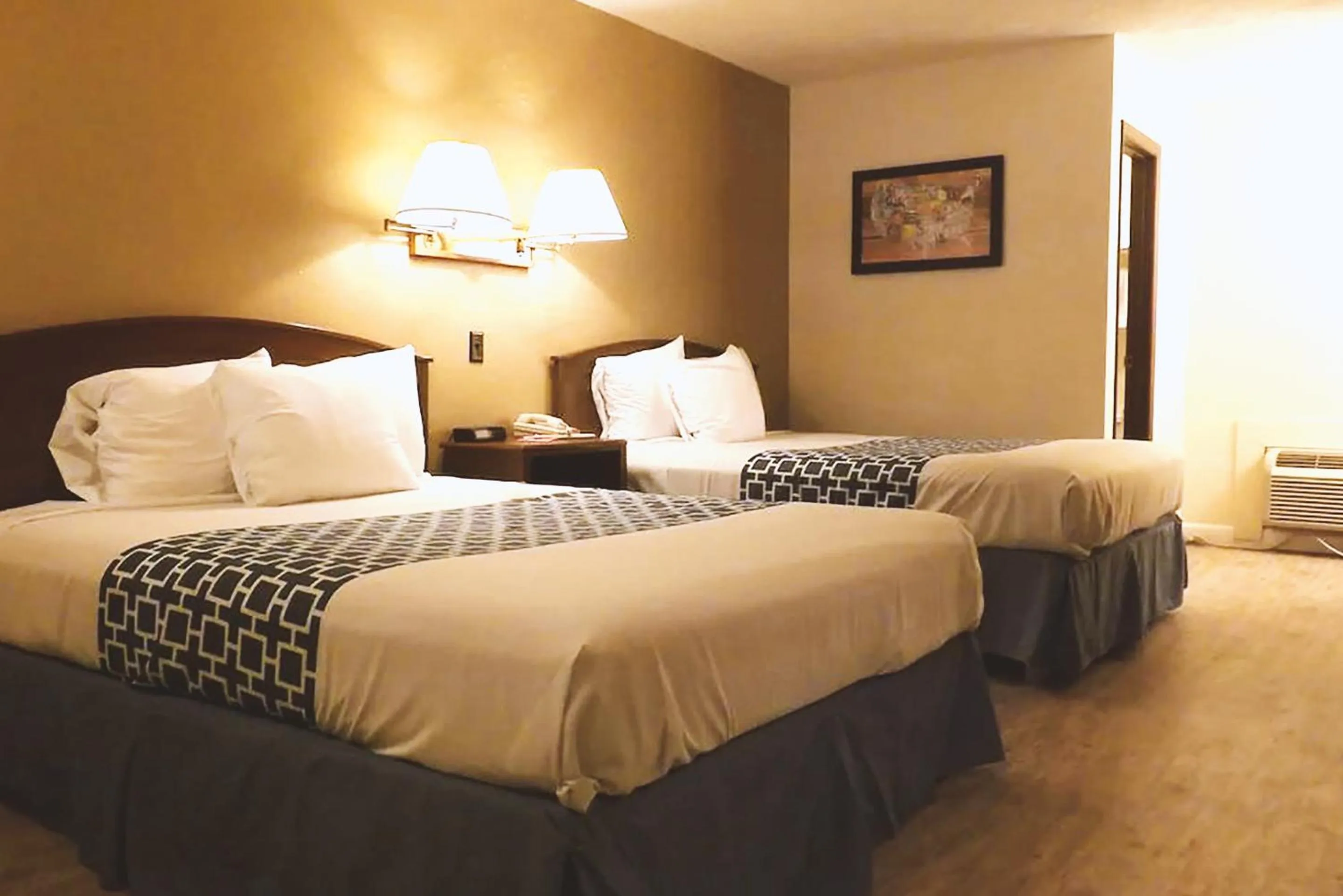 Bed in Coratel Inn & Suites by Jasper McCook
