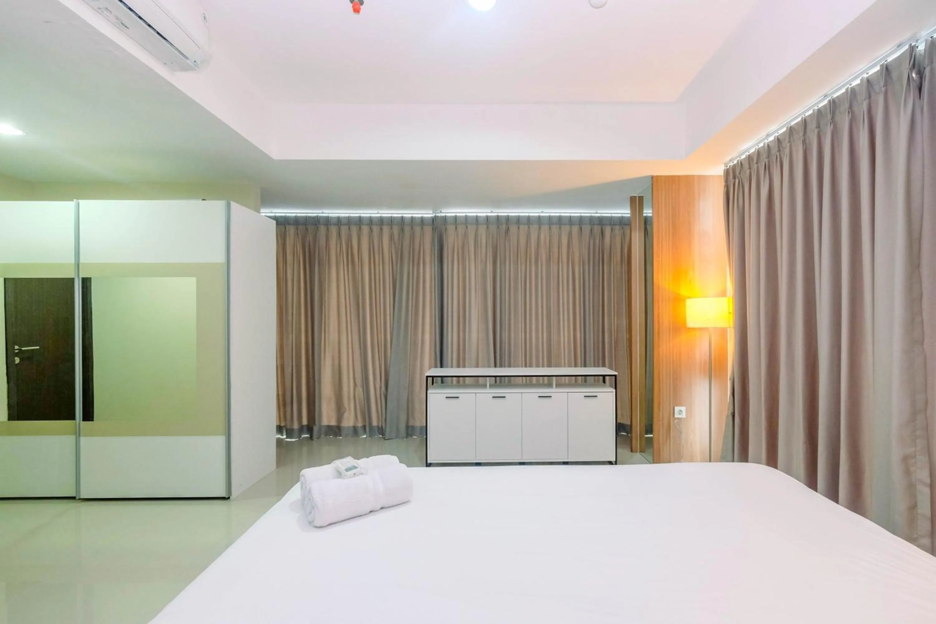 Bed in Cozy 2BR Apartment Nine Residence with City View By Travelio