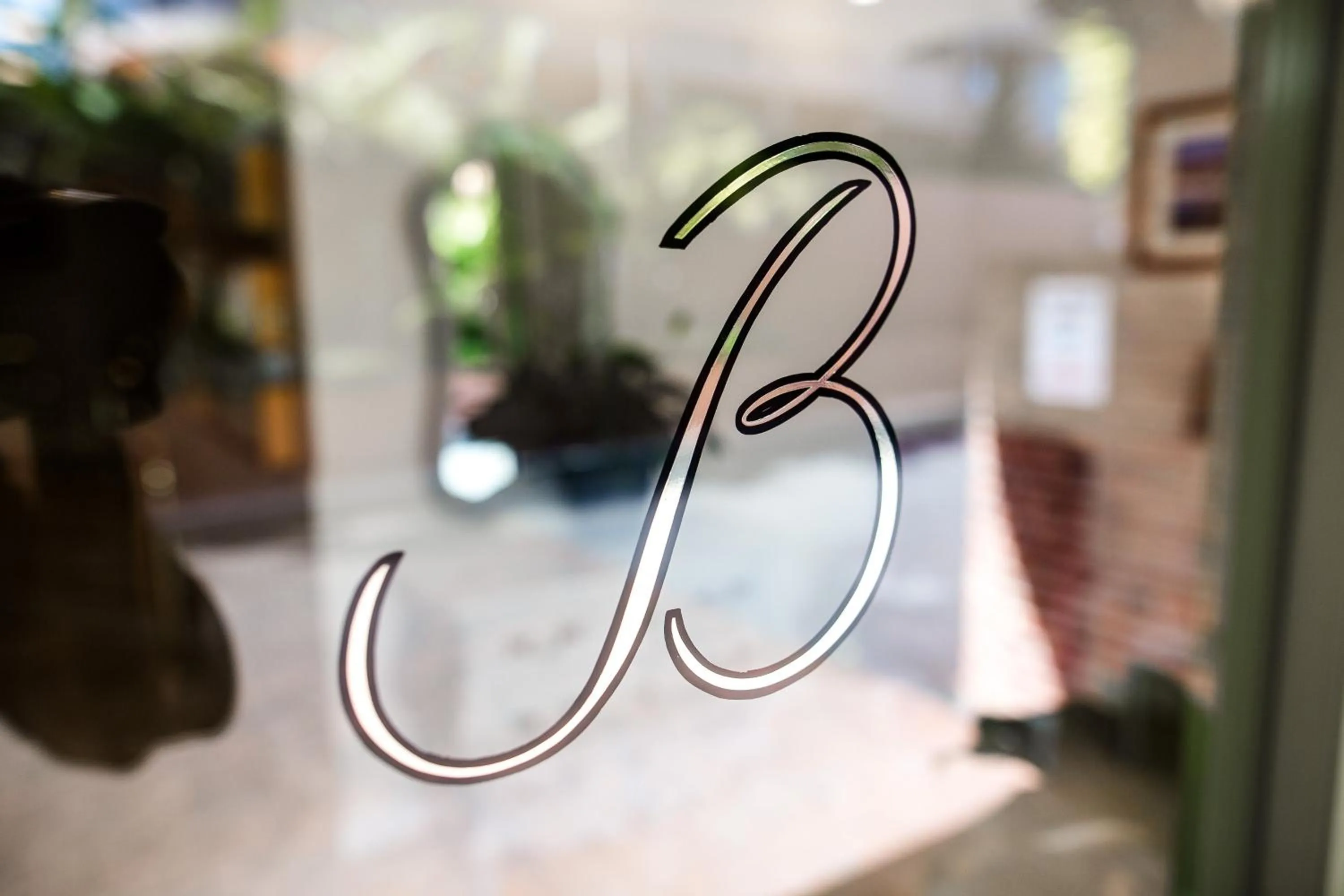 Property logo or sign in The Belmore Apartments Hotel