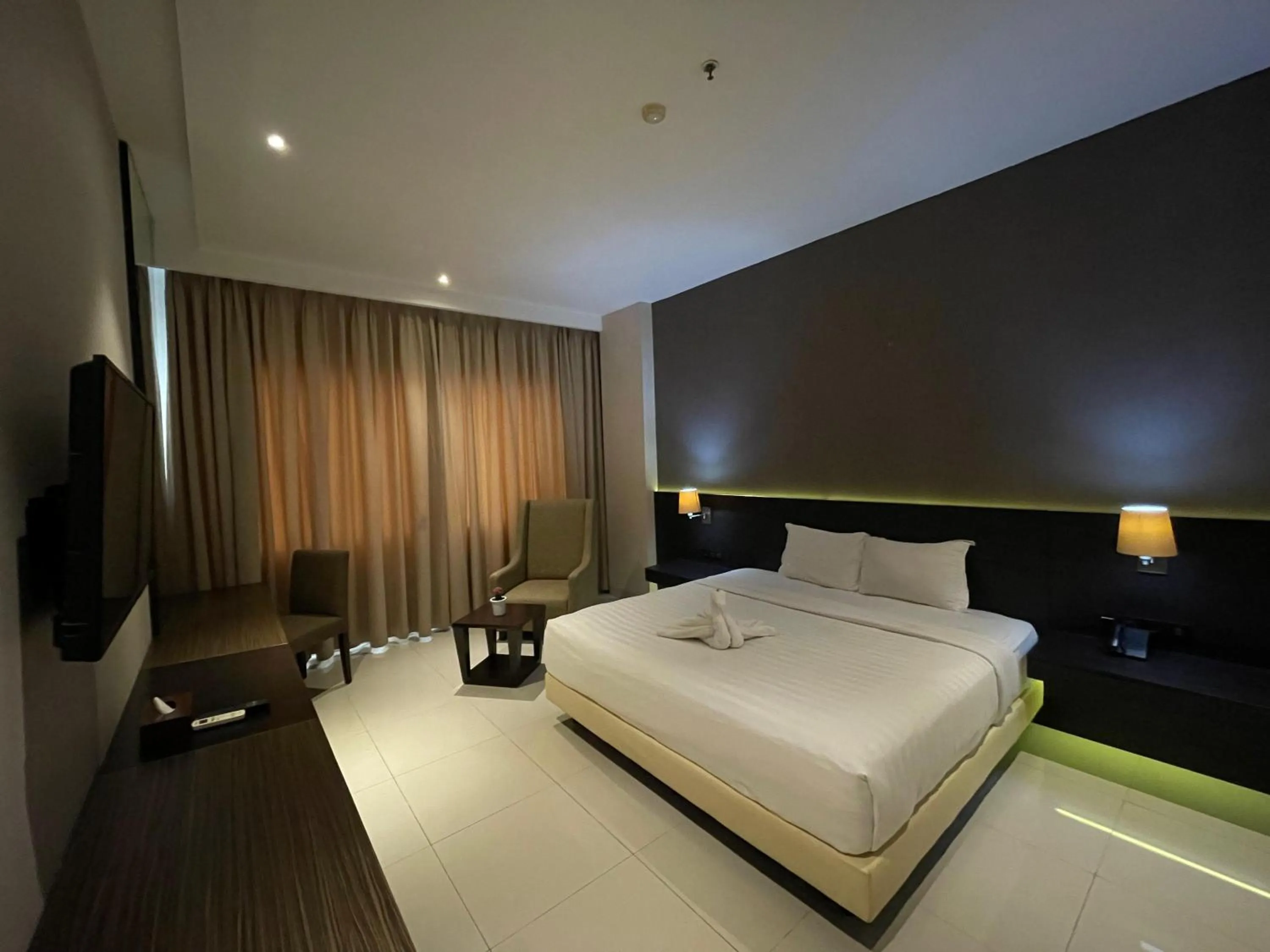 Bed in Grand Arjuna Hotel