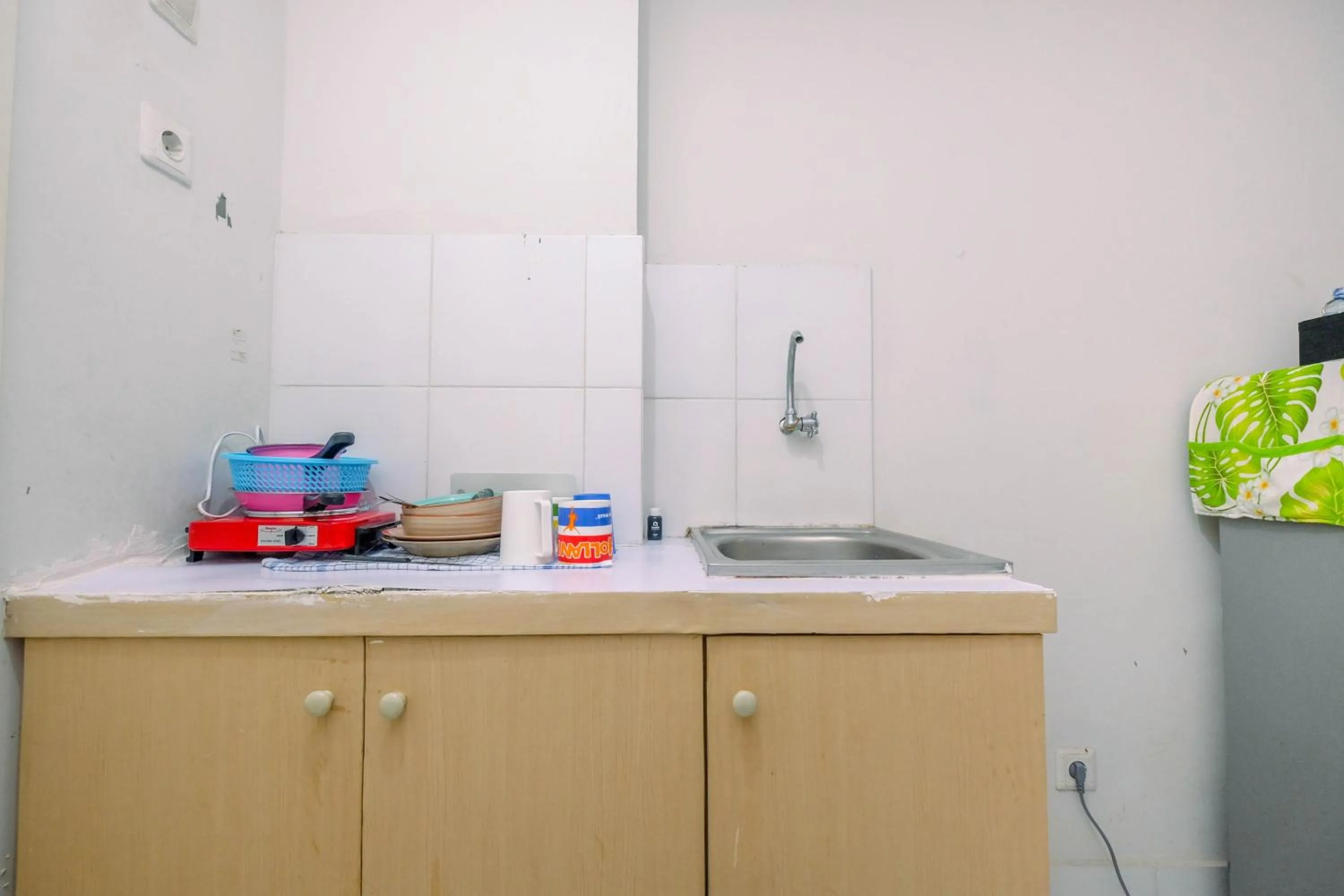 Kitchen or kitchenette in Comfortable and Homey Studio Apartment at Dramaga Tower near IPB By Travelio