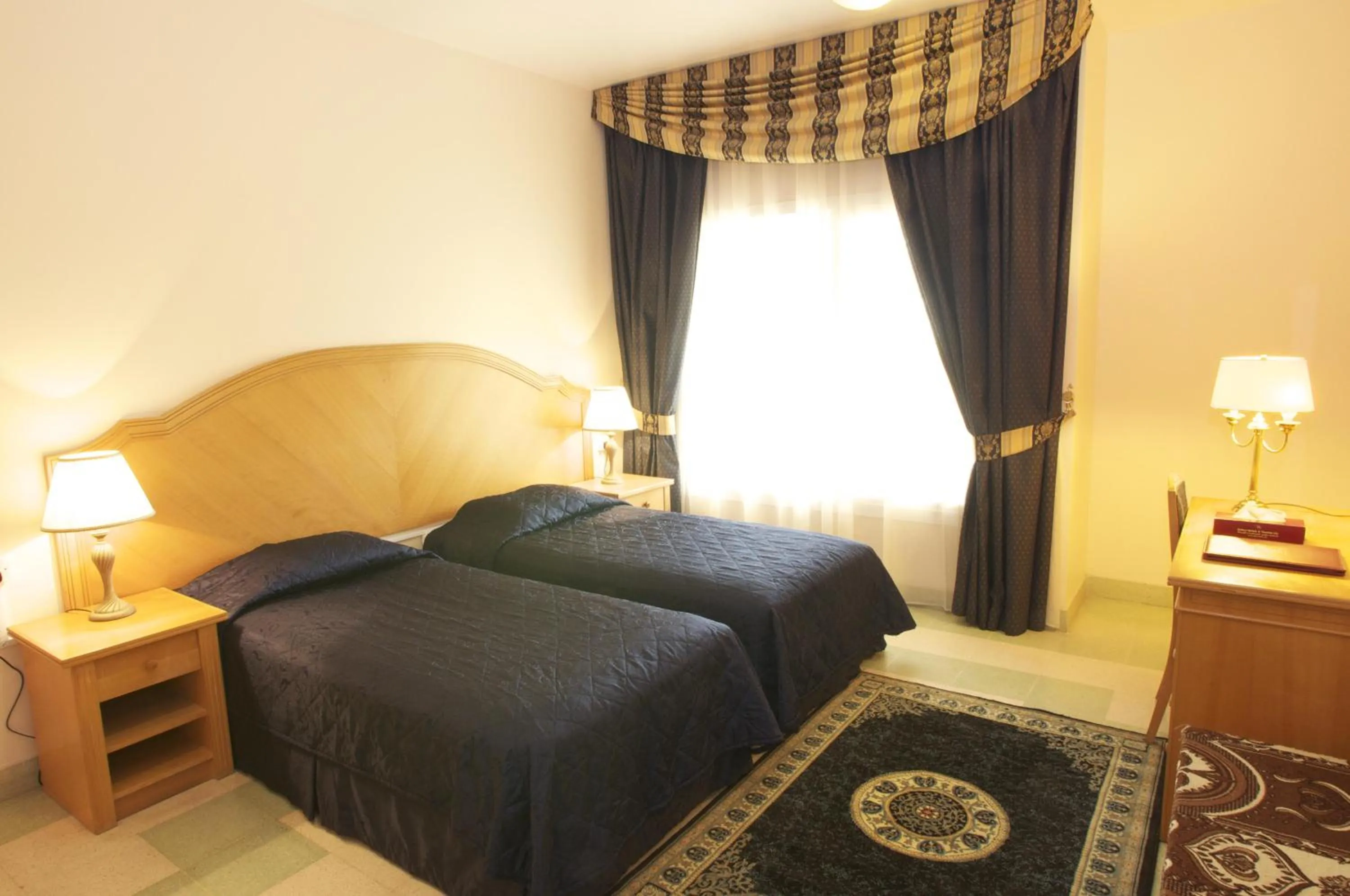 Bed in Safeer Hotel Suites