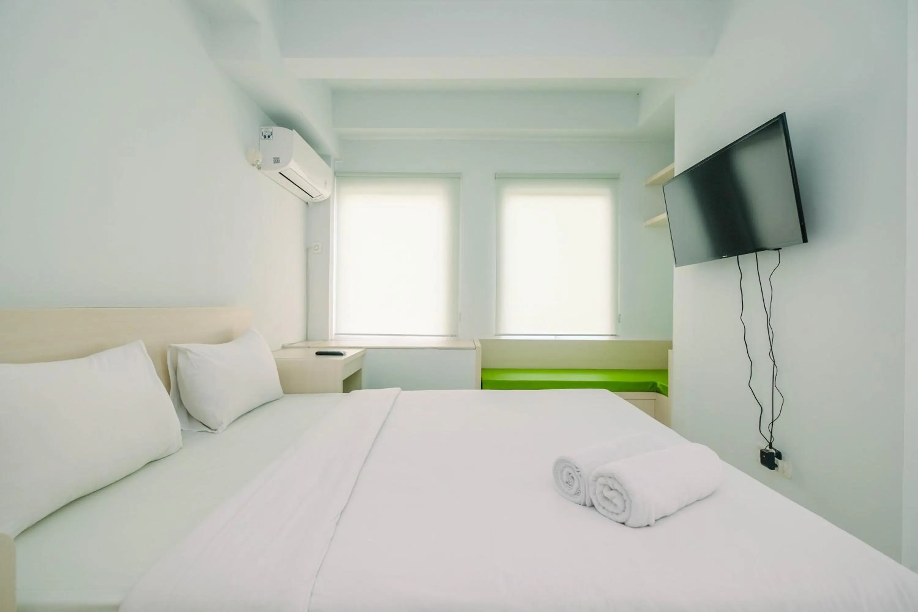 Bed in Comfy and Minimalist 1BR Patraland Urbano Apartment near Bekasi Station By Travelio