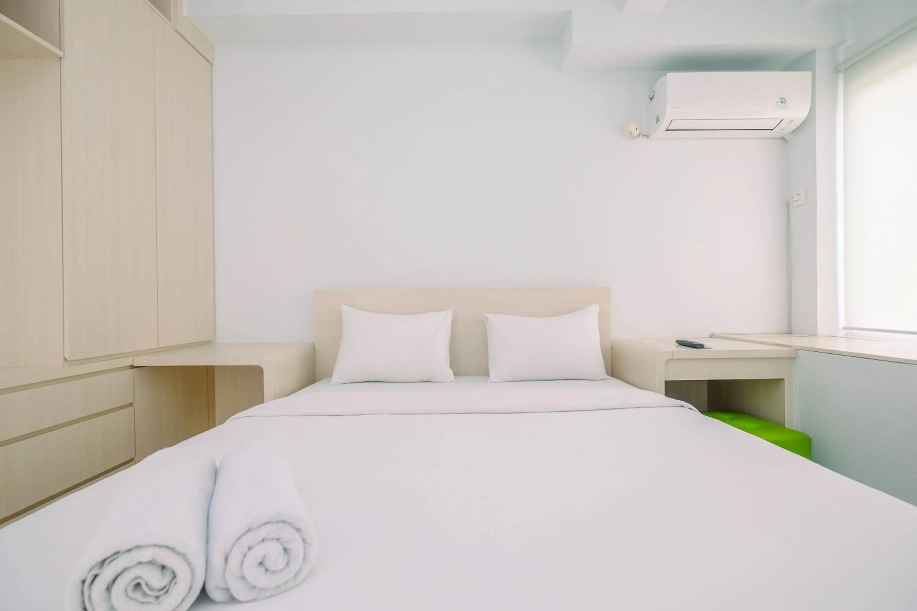 Bed in Comfy and Minimalist 1BR Patraland Urbano Apartment near Bekasi Station By Travelio