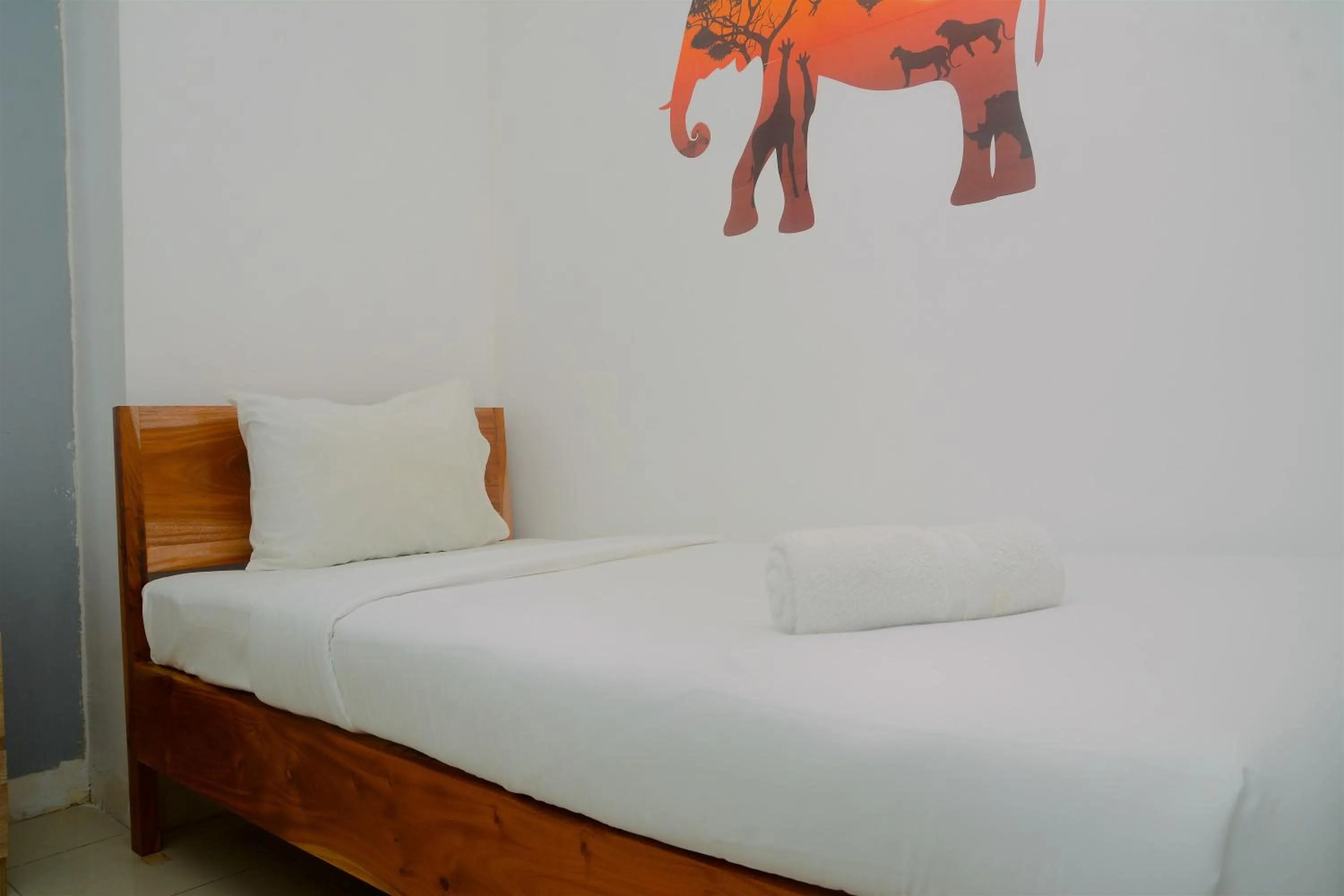 Bed in Best Deal 3BR Apartment Bassura City near Shopping Center By Travelio