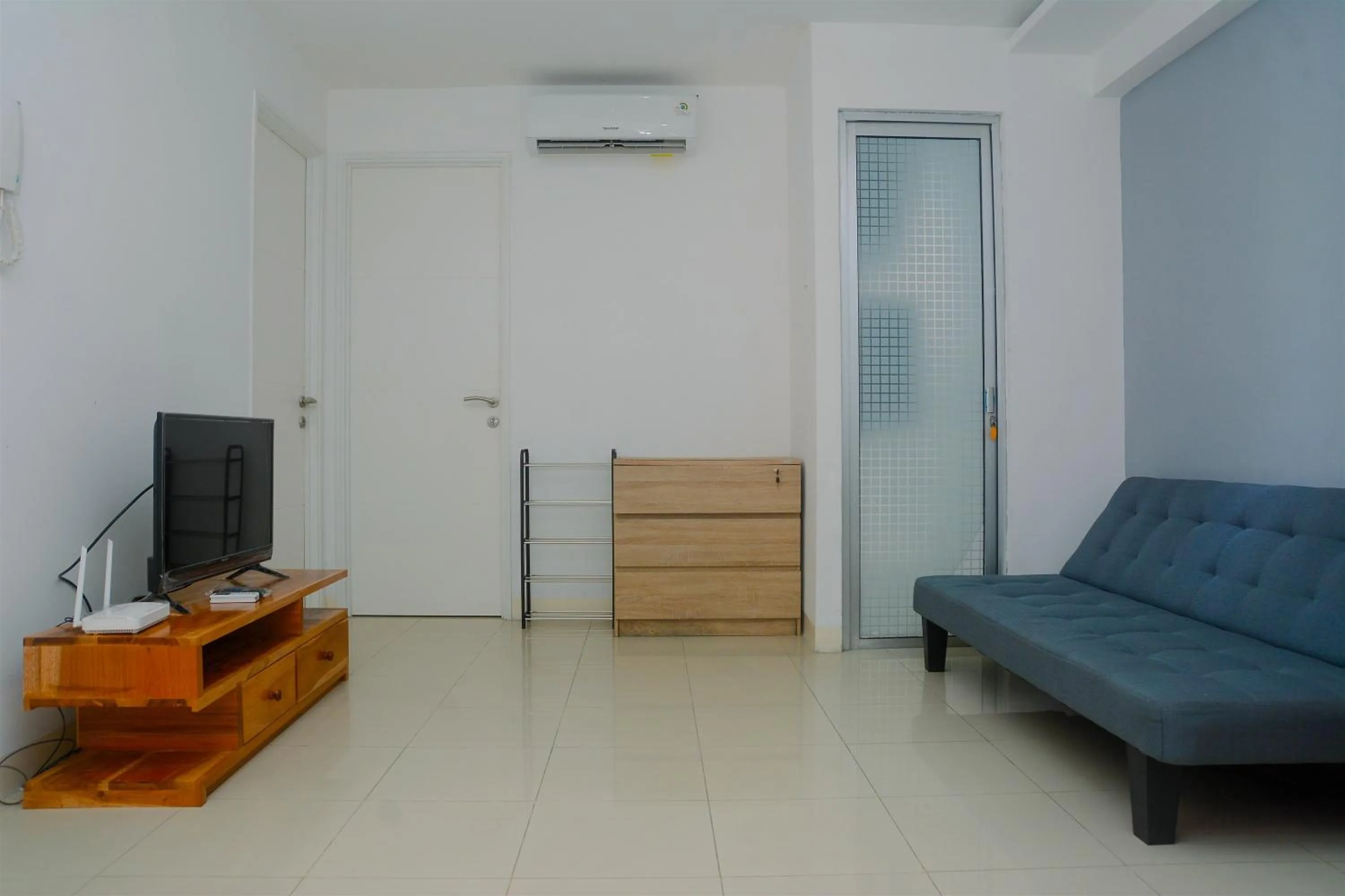 Living room in Best Deal 3BR Apartment Bassura City near Shopping Center By Travelio