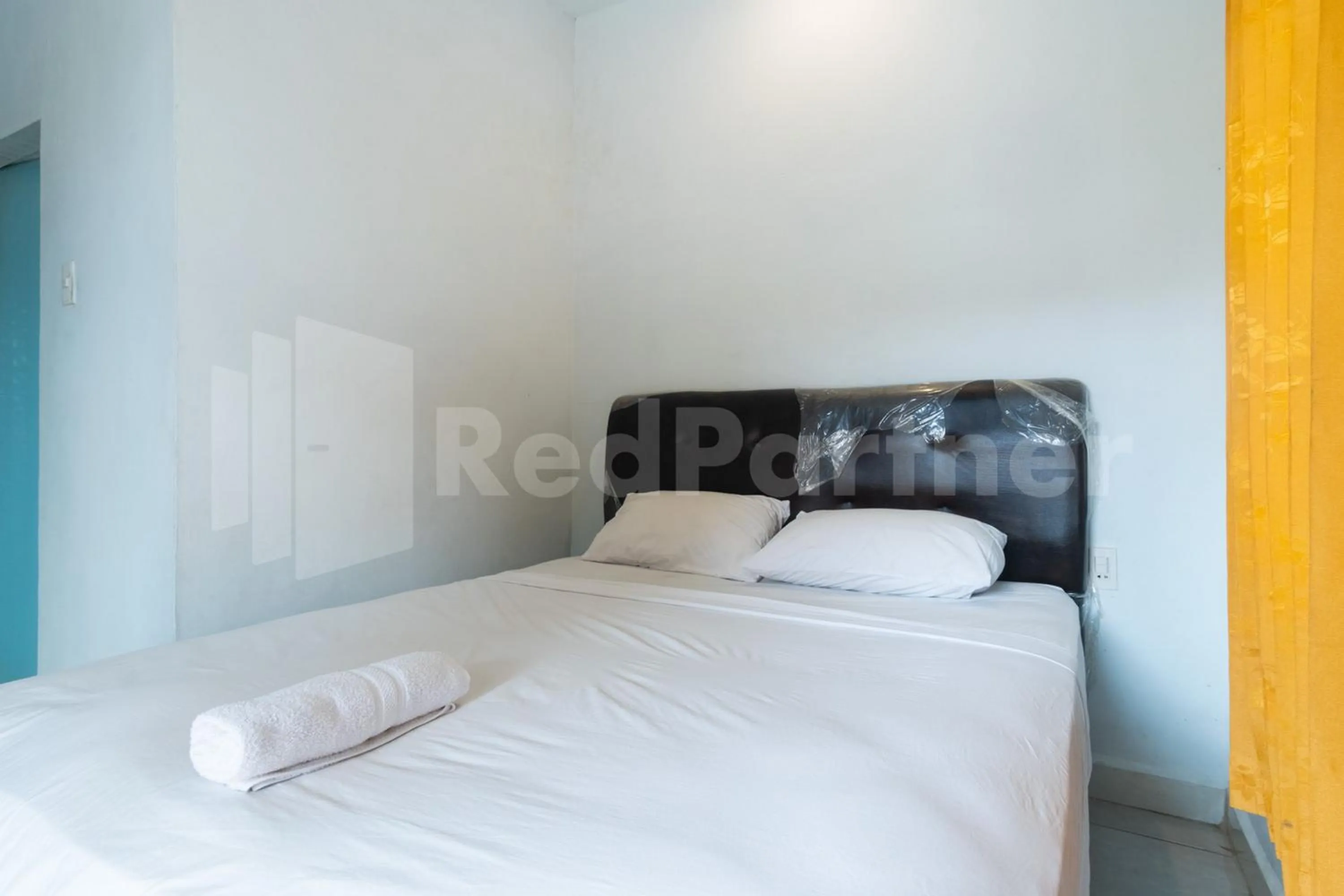 Bed in Teratai Guesthouse at RS Adam Malik Medan Mitra RedDoorz