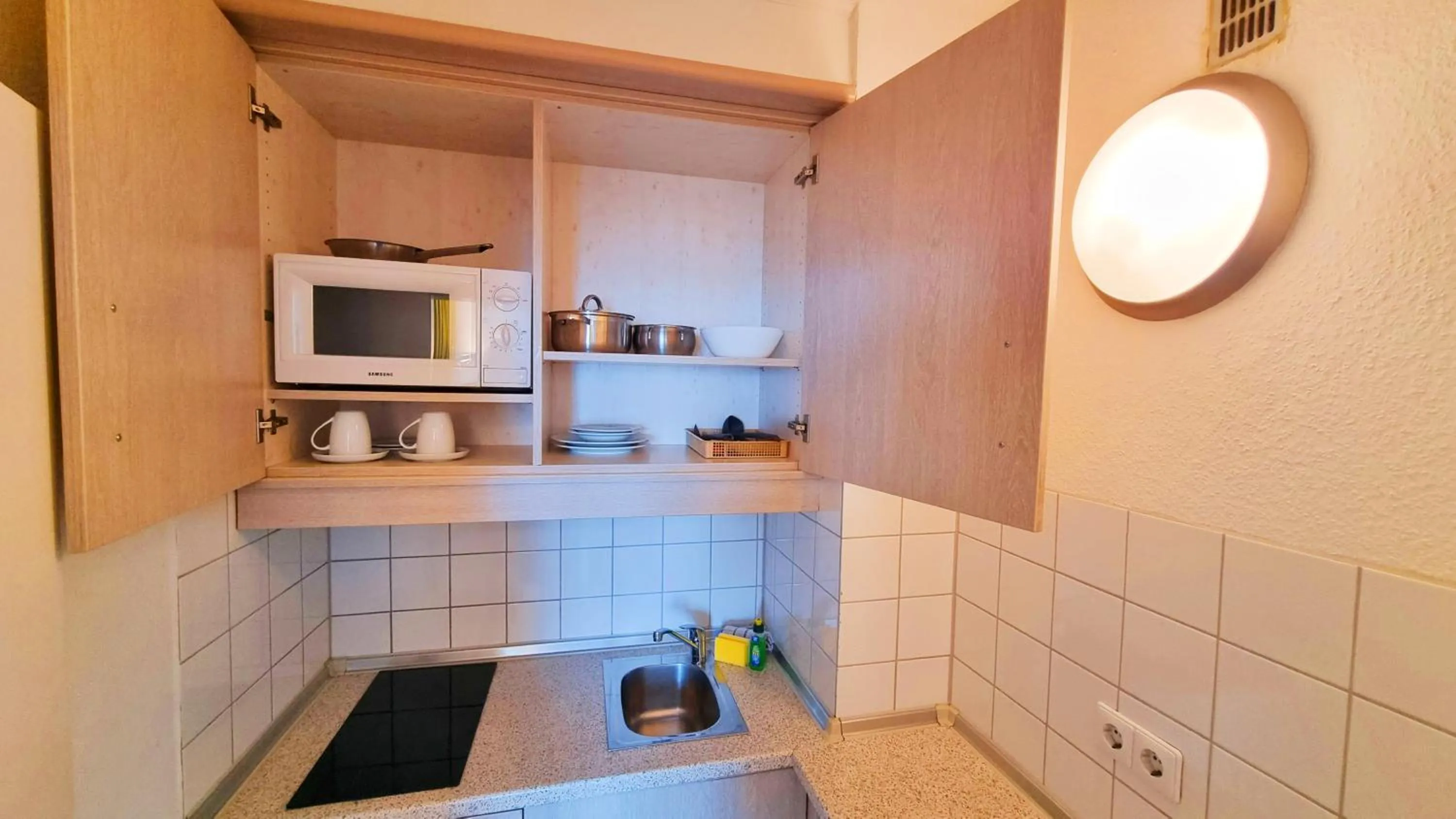 Kitchen or kitchenette in Panorama Inn Hotel und Boardinghaus