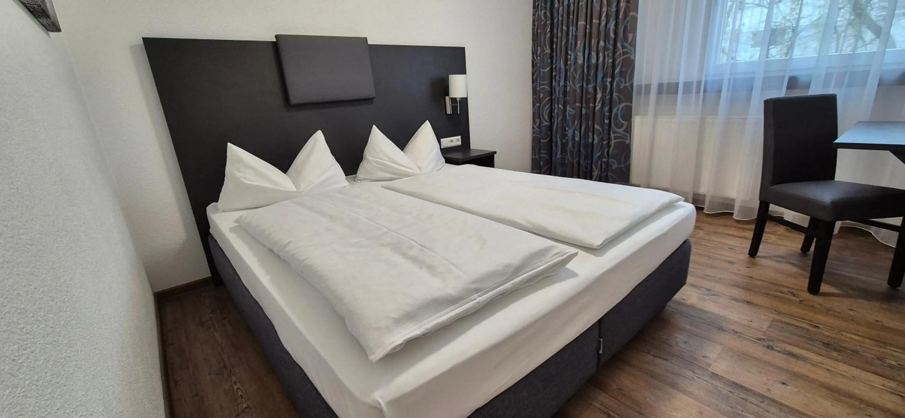 Photo of the whole room, Bed in Melvi Hotel Göppingen