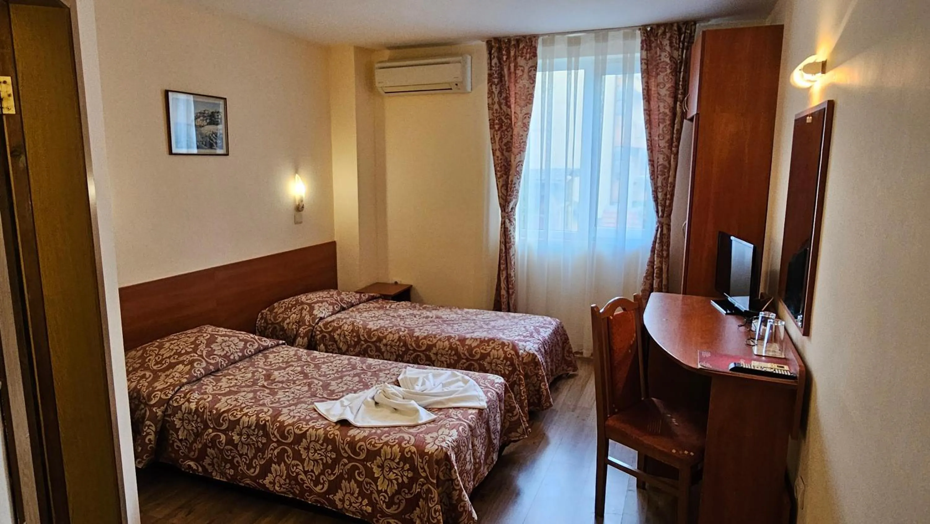 Bed in Caprice Family Hotel