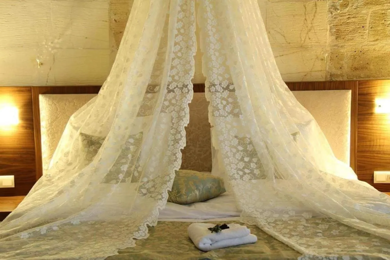 Bed in Tuğhan Hotel