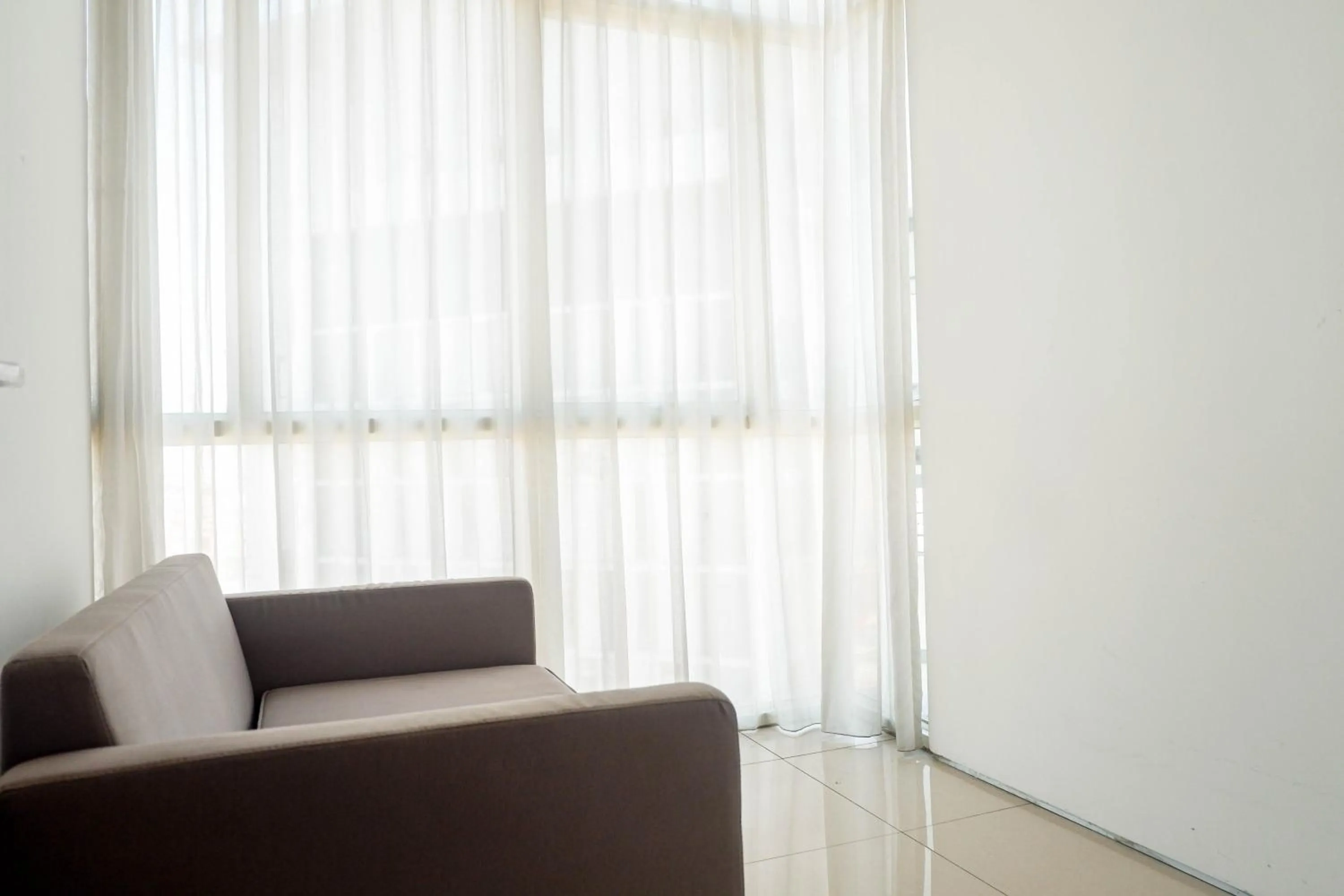 Living room in 1BR Apartment The Linden Connected to Marvell City Mall By Travelio