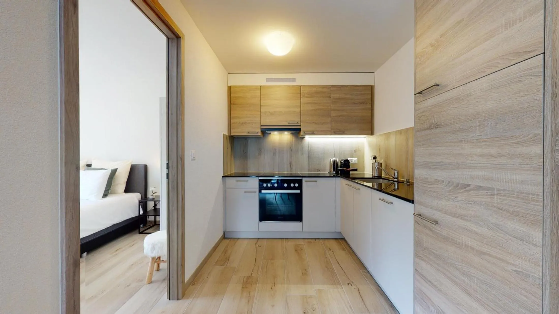 Kitchen or kitchenette in Nonanteneuf appart hōtel Aigle - contactless check-in